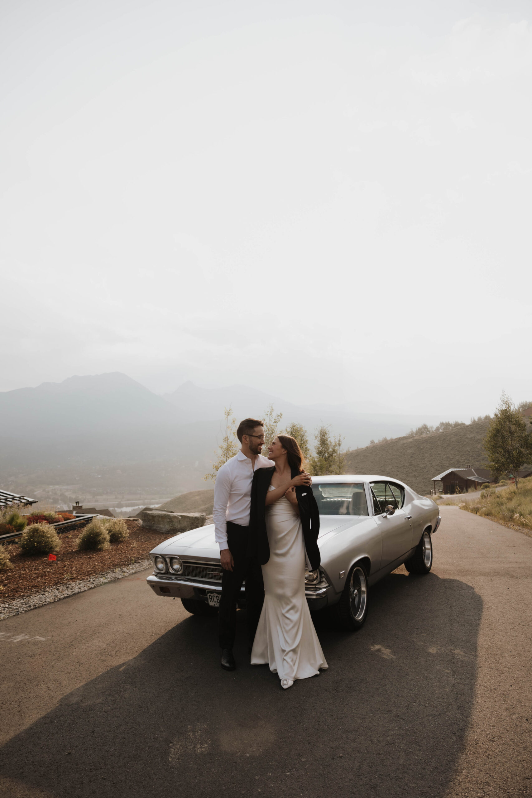 bride and groom portraits in front of a vintage car 