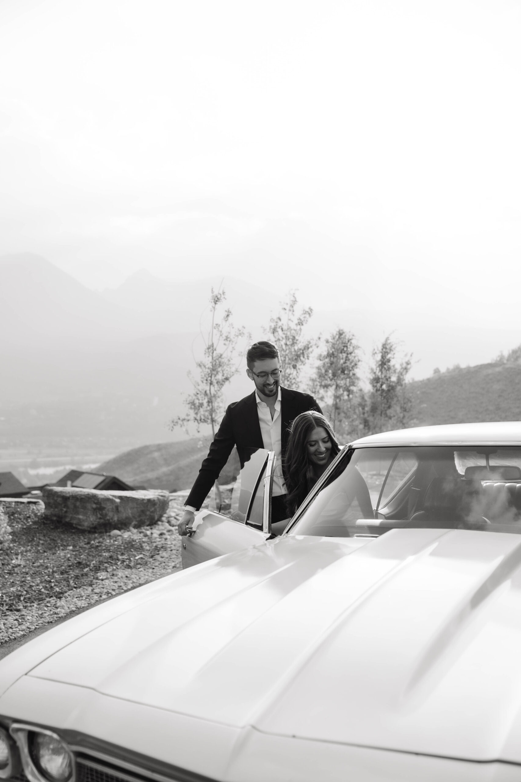 bride and groom getting into a classic car 