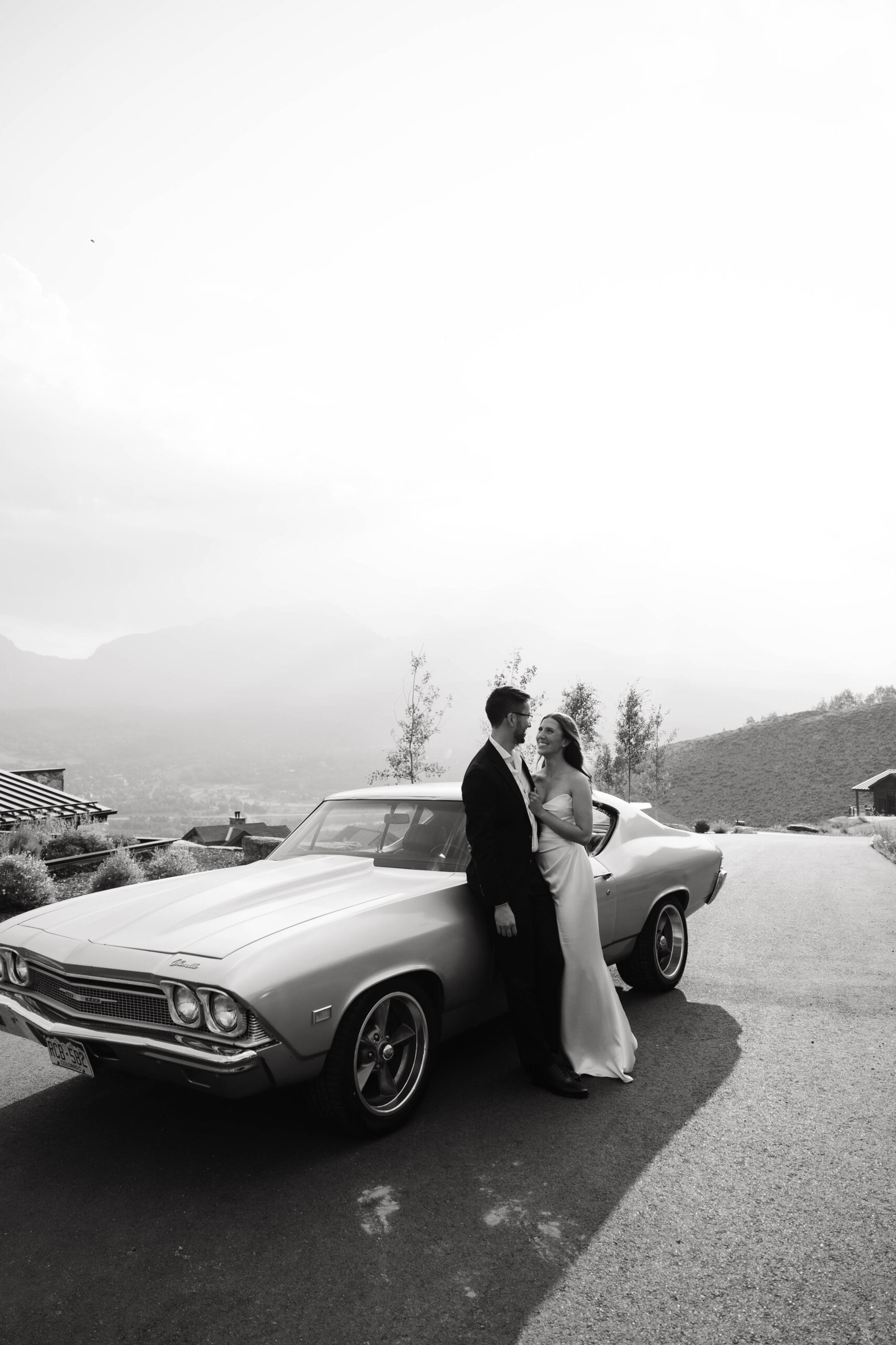 bride and groom portraits in front of a classic car