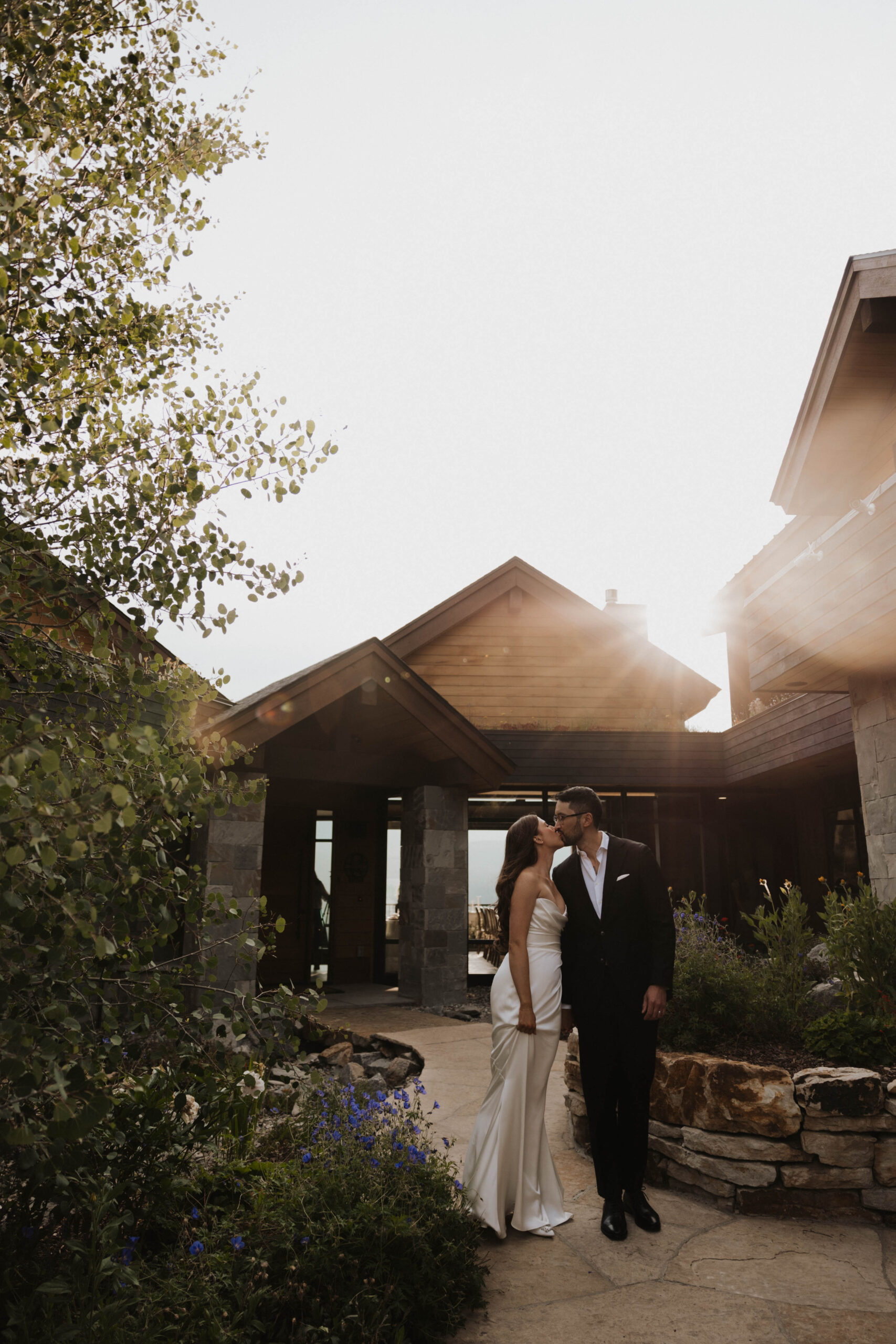 bride and groom kissing outside their Colorado micro wedding airbnb