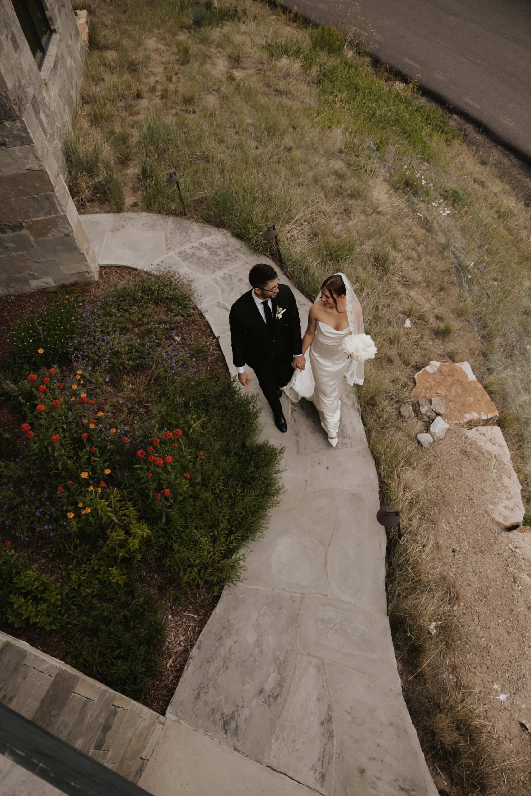 bride and groom walking outside 