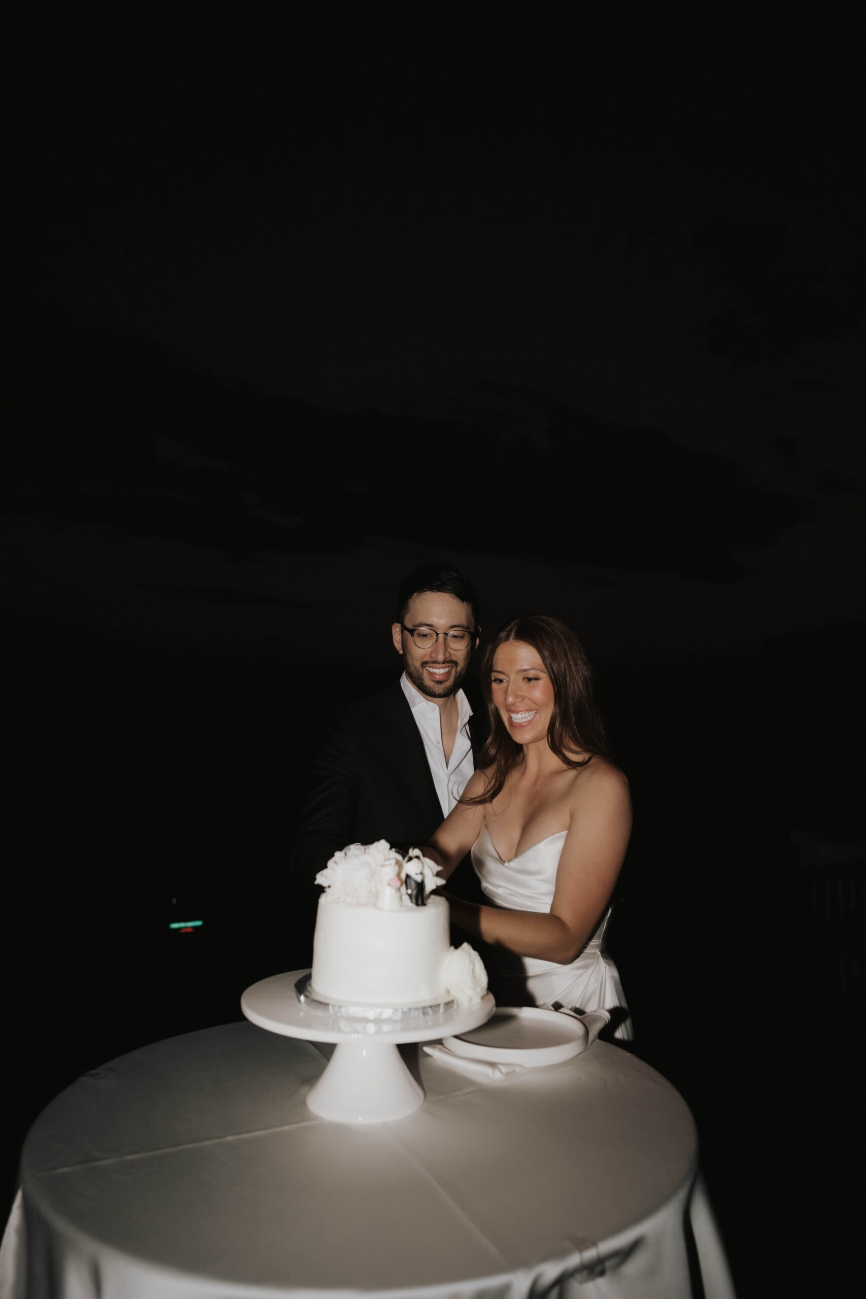 bride and groom cutting their wedding cake 