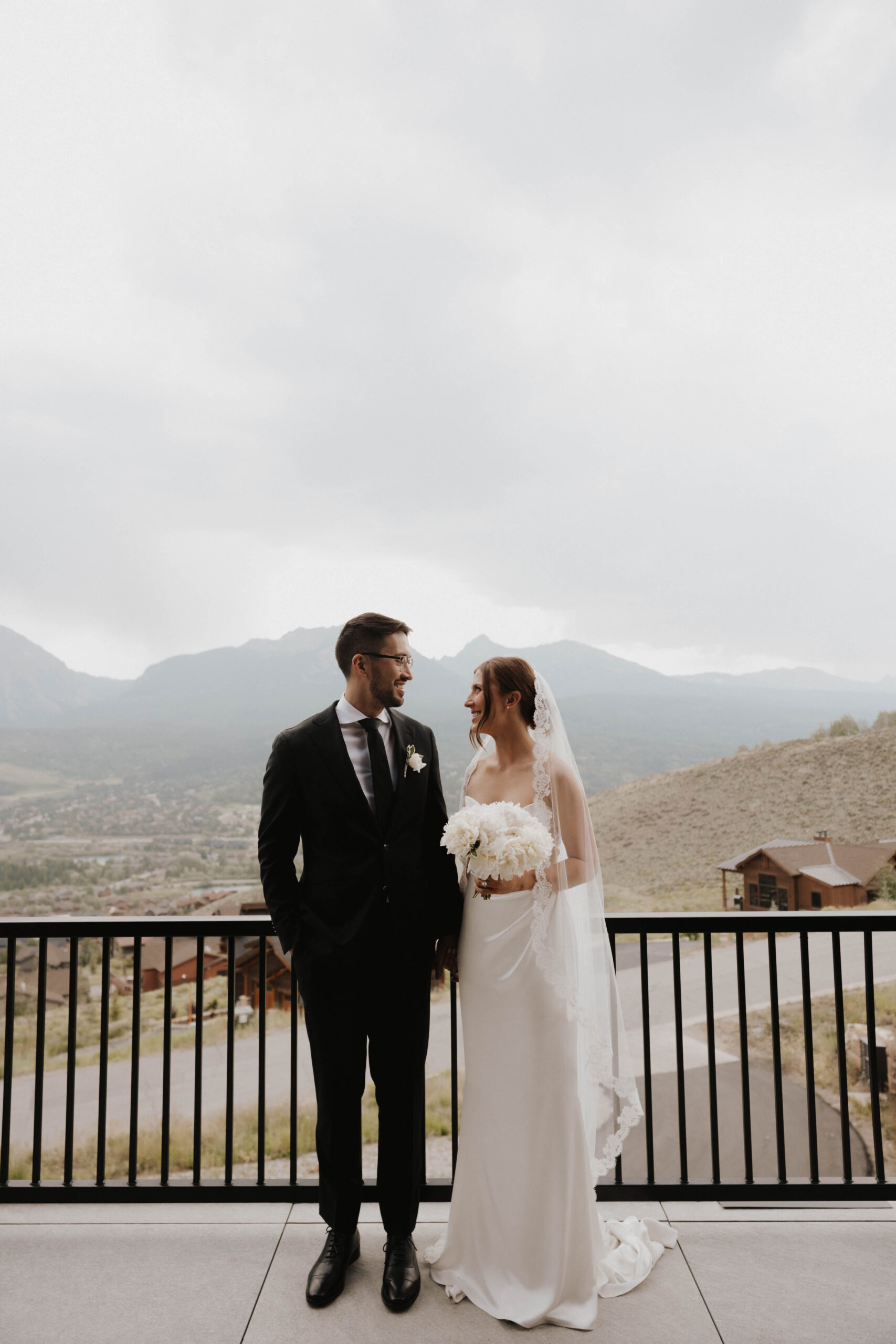 bride and groom portrait with a mountain background 