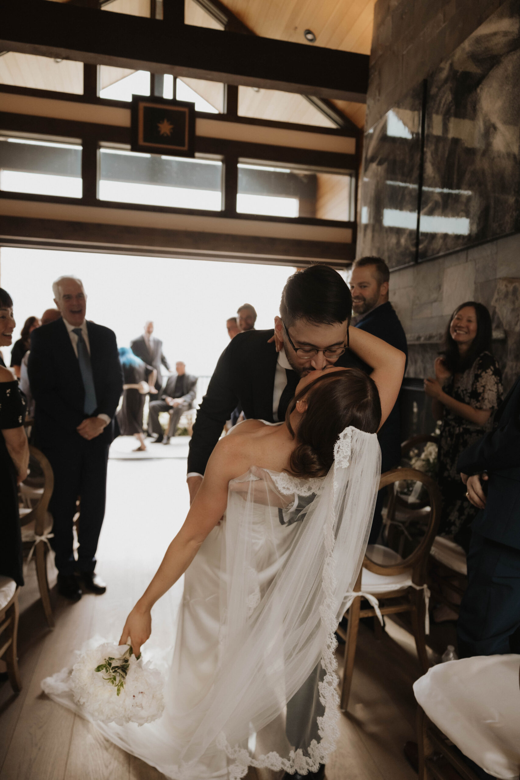 bride and groom kissing at the end of the aisle 