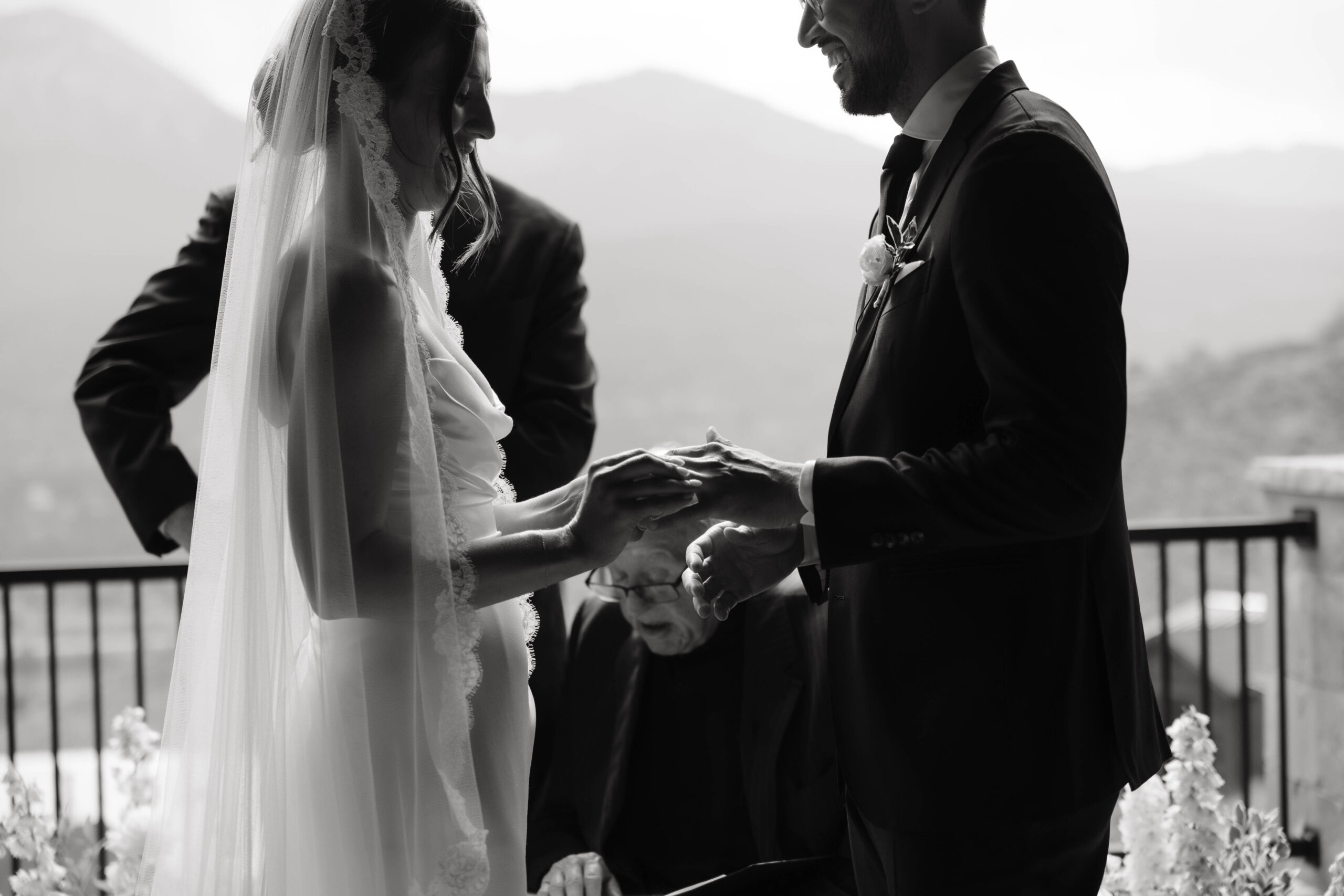 bride putting on groom's ring 