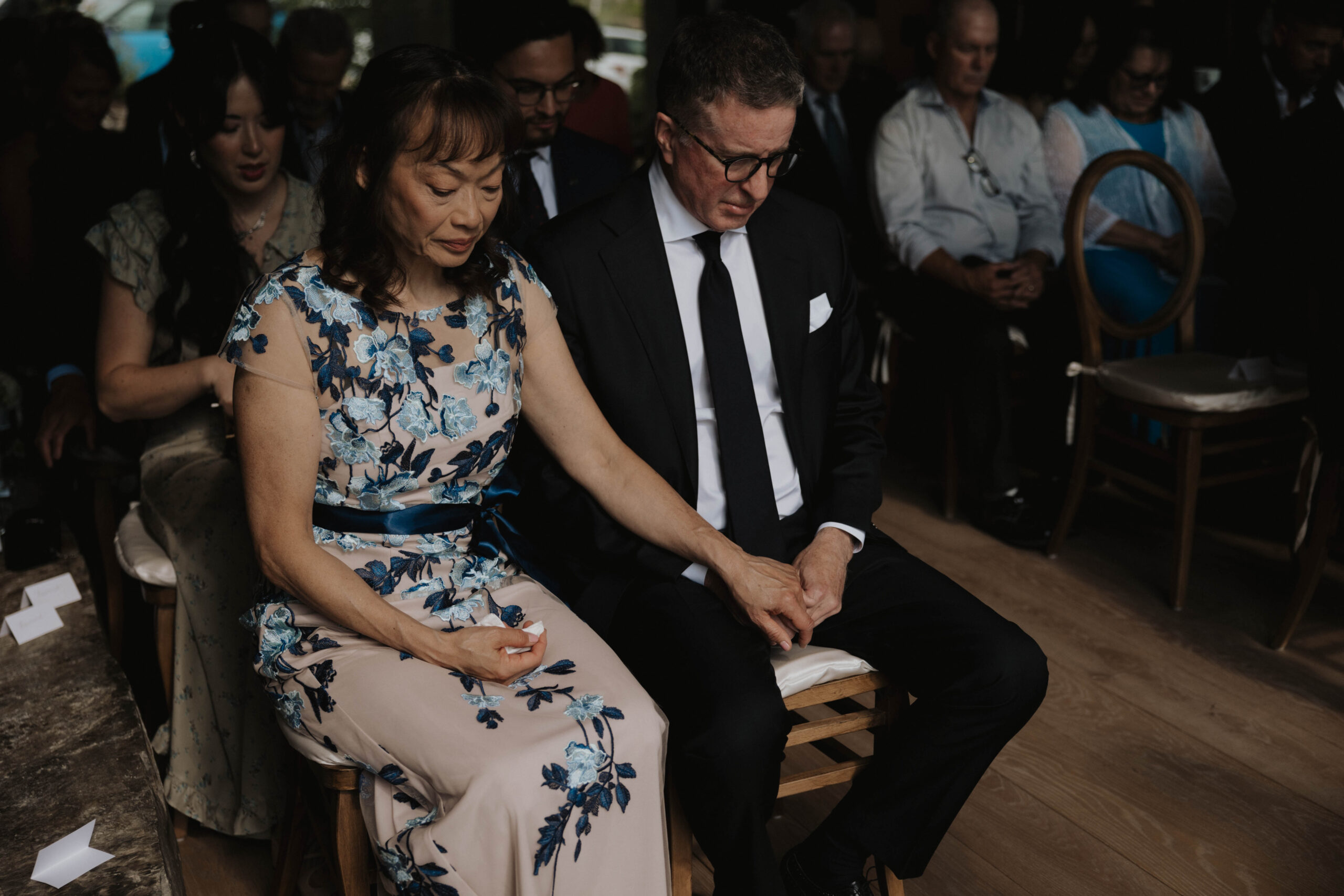 groom's parents praying at the Colorado micro wedding ceremony