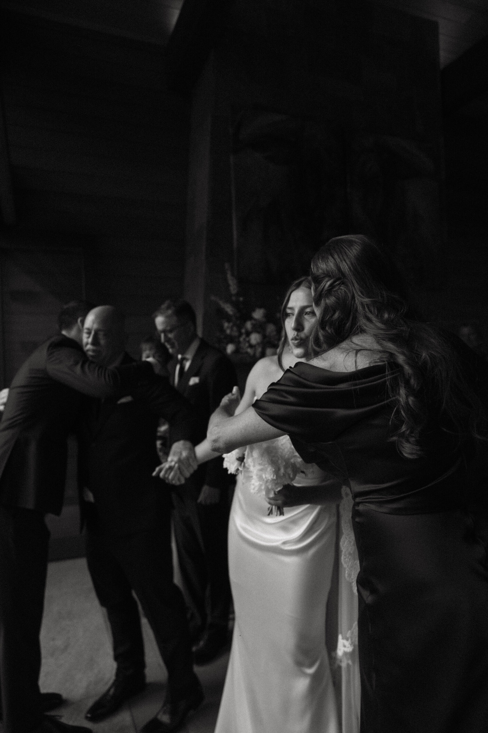 bride's mother kissing her on the cheek 