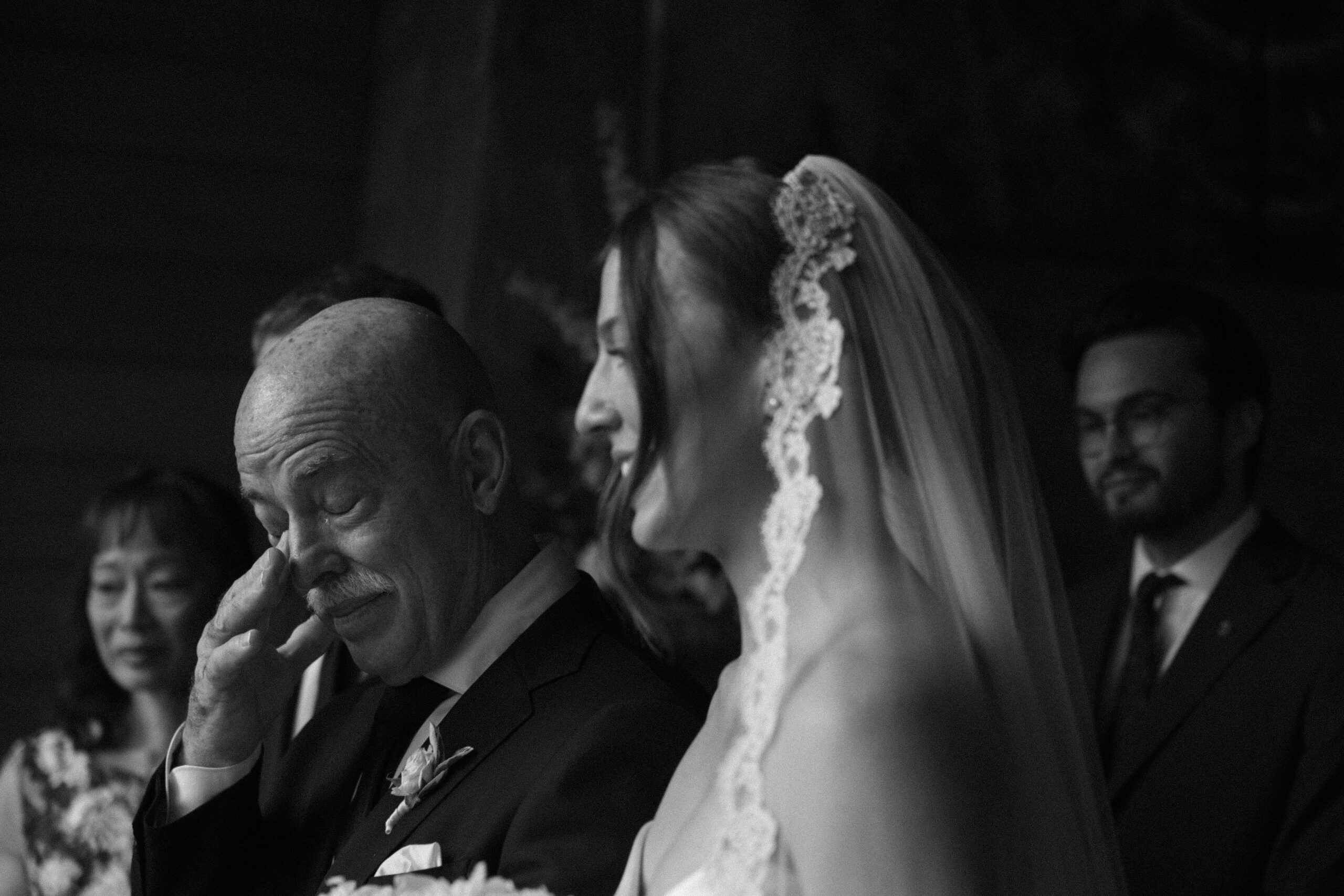 dad tearing up as they walk down the aisle together 