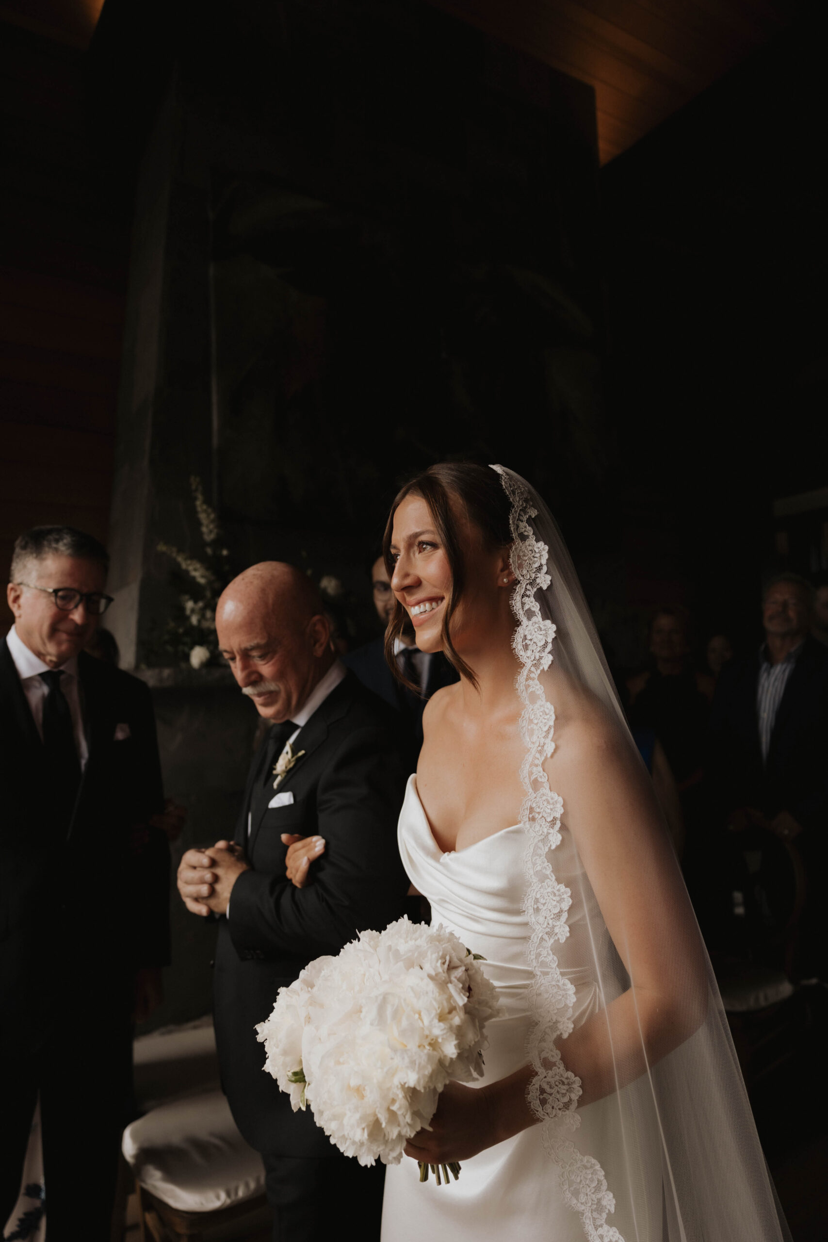 bride smiling as she walks down Colorado micro wedding aisle 