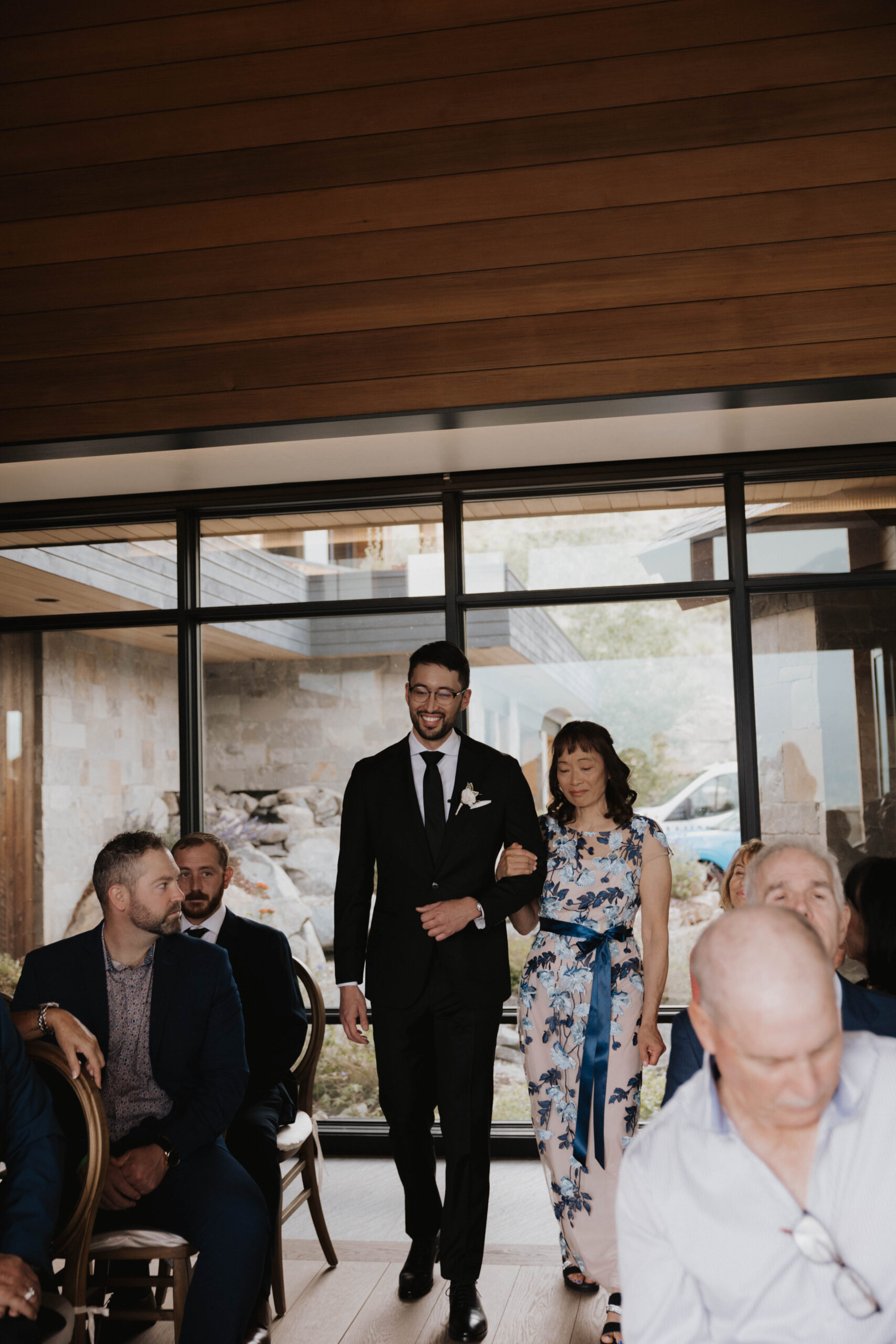 groom walking his mother to her seat at Colorado micro wedding