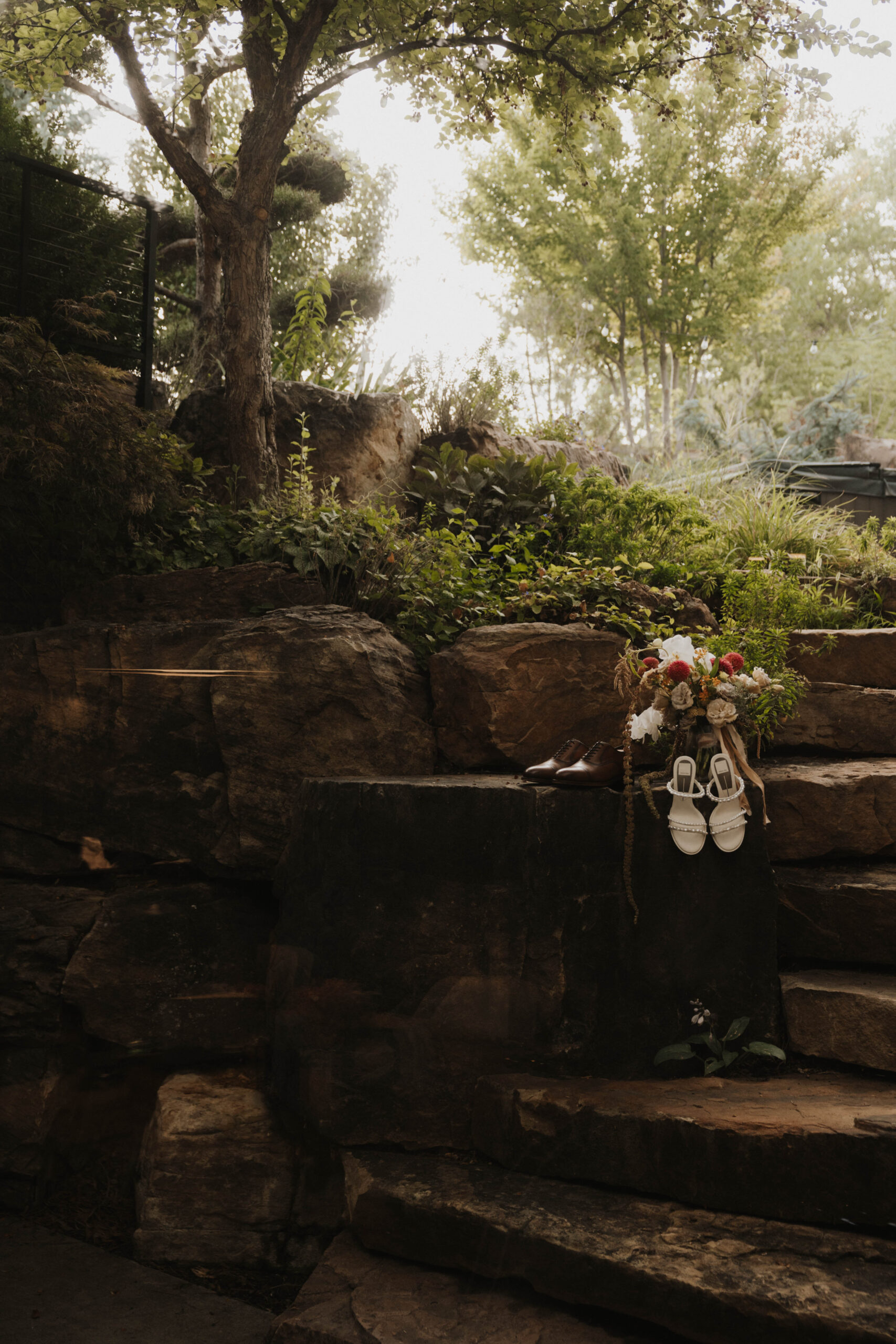 bride and groom's shoes and flowers