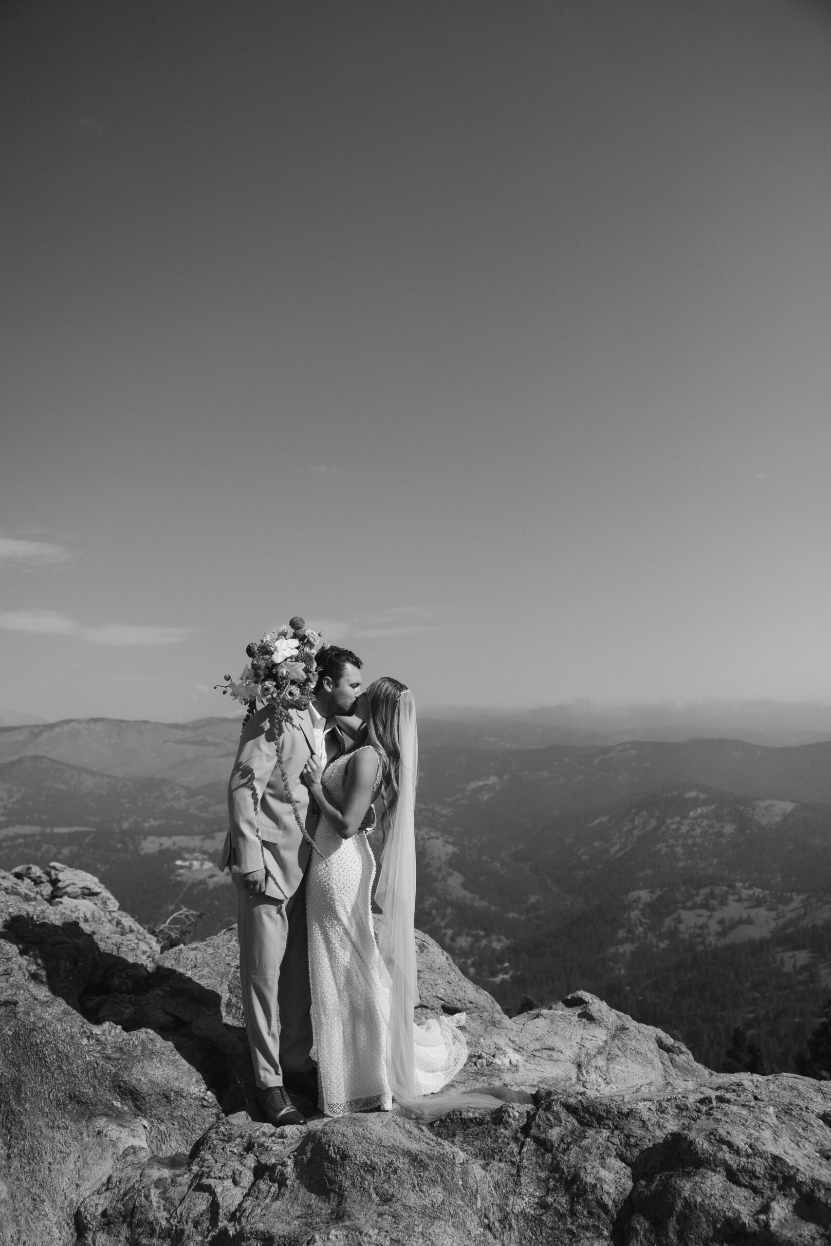 bride and groom portrait on top of a mountain before Boulder Colorado wedding