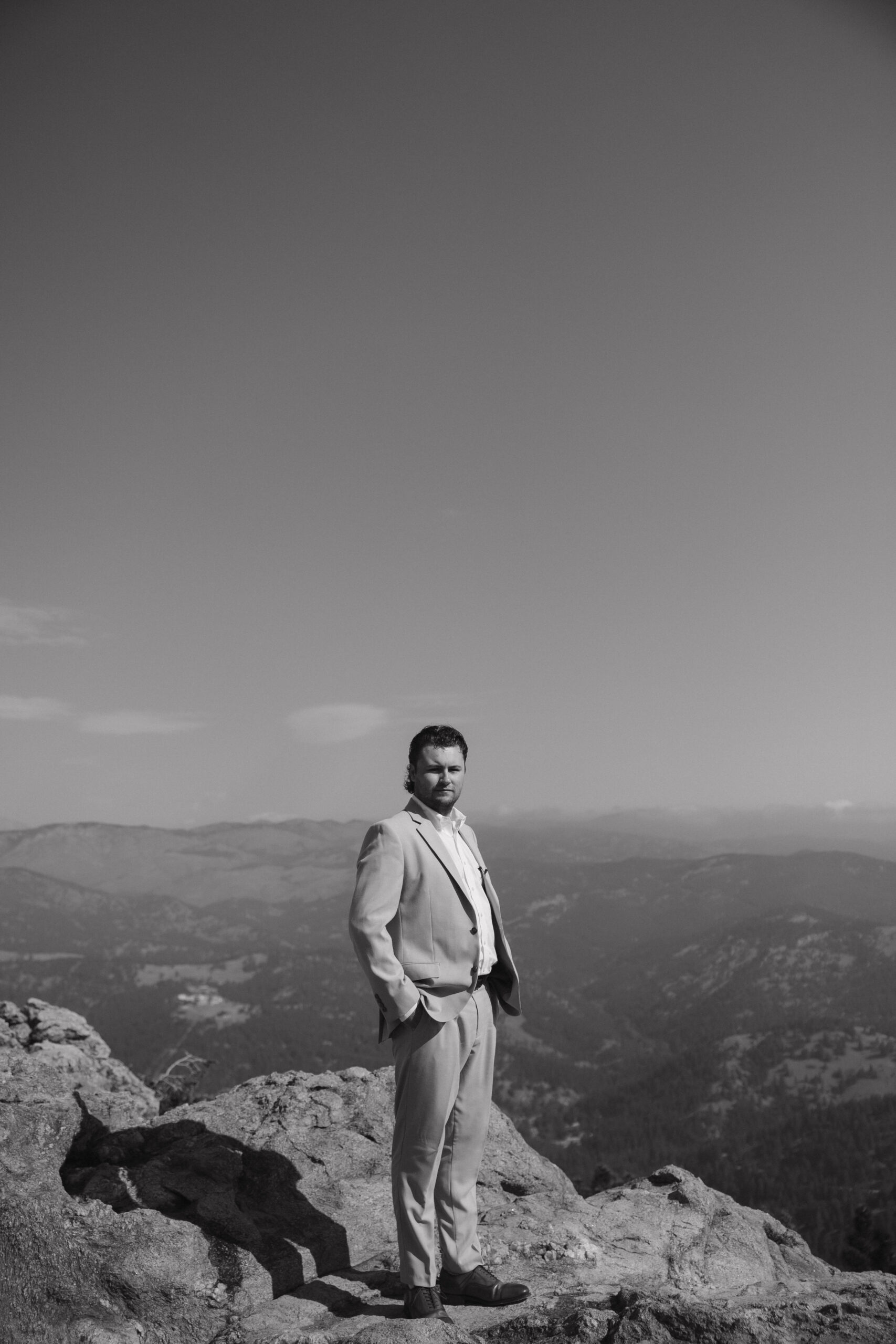 groom portrait on top of a mountain