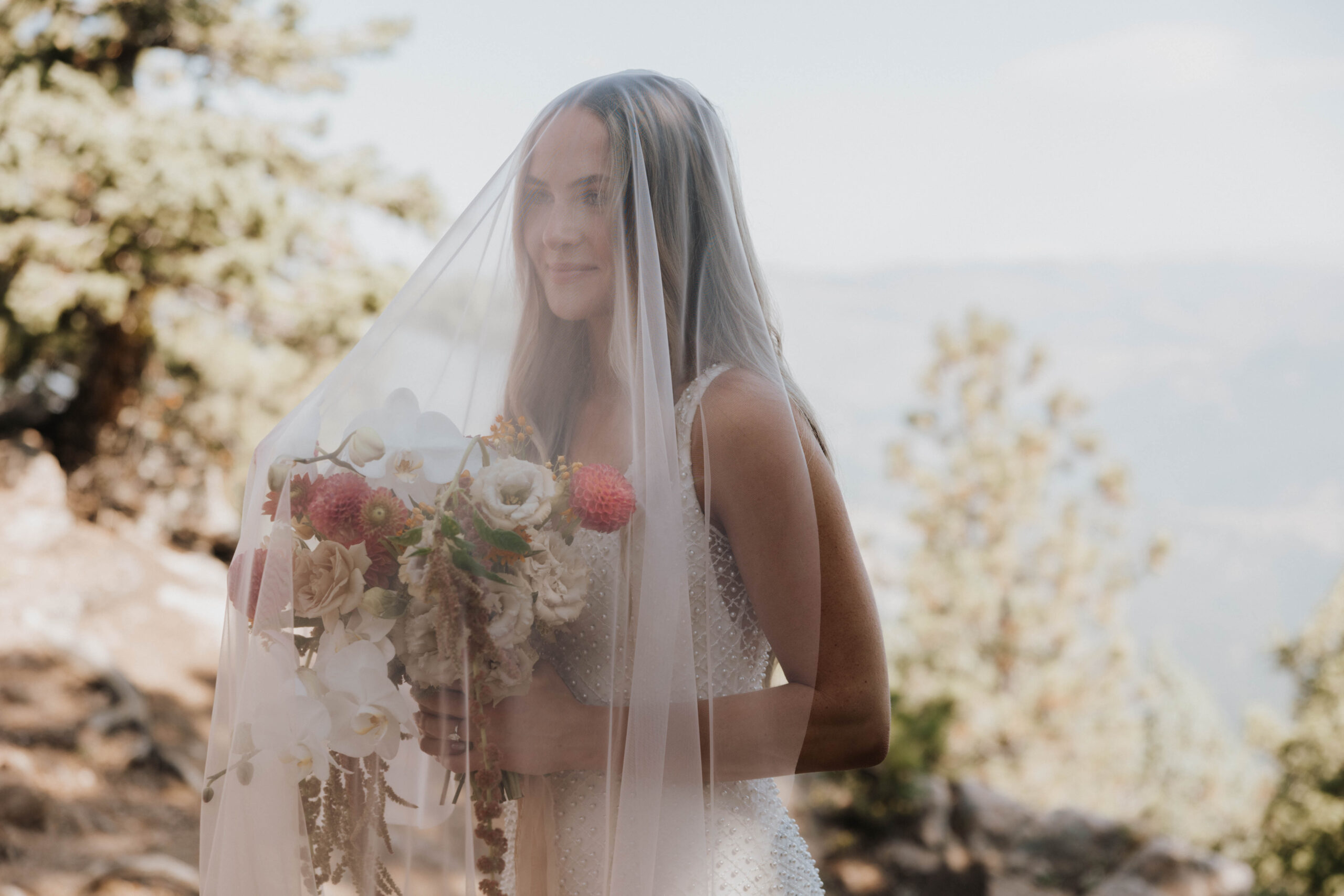 bride holding her flowers under her veil at a Boulder Colorado wedding