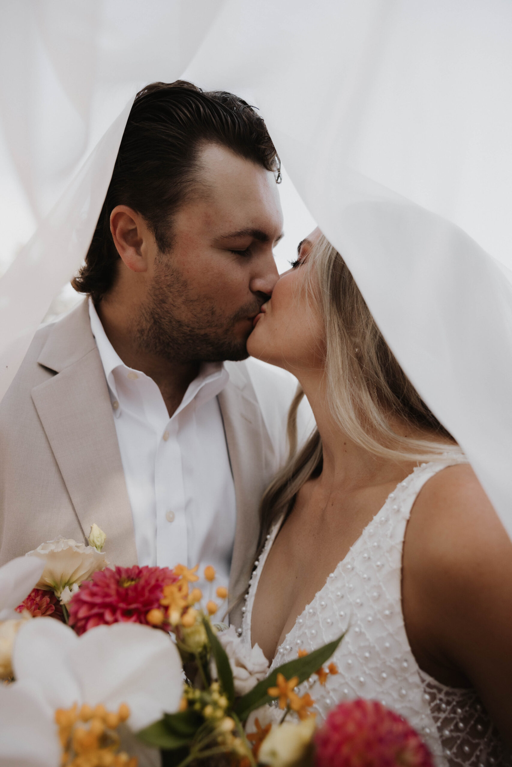 under the veil bride and groom portrait 