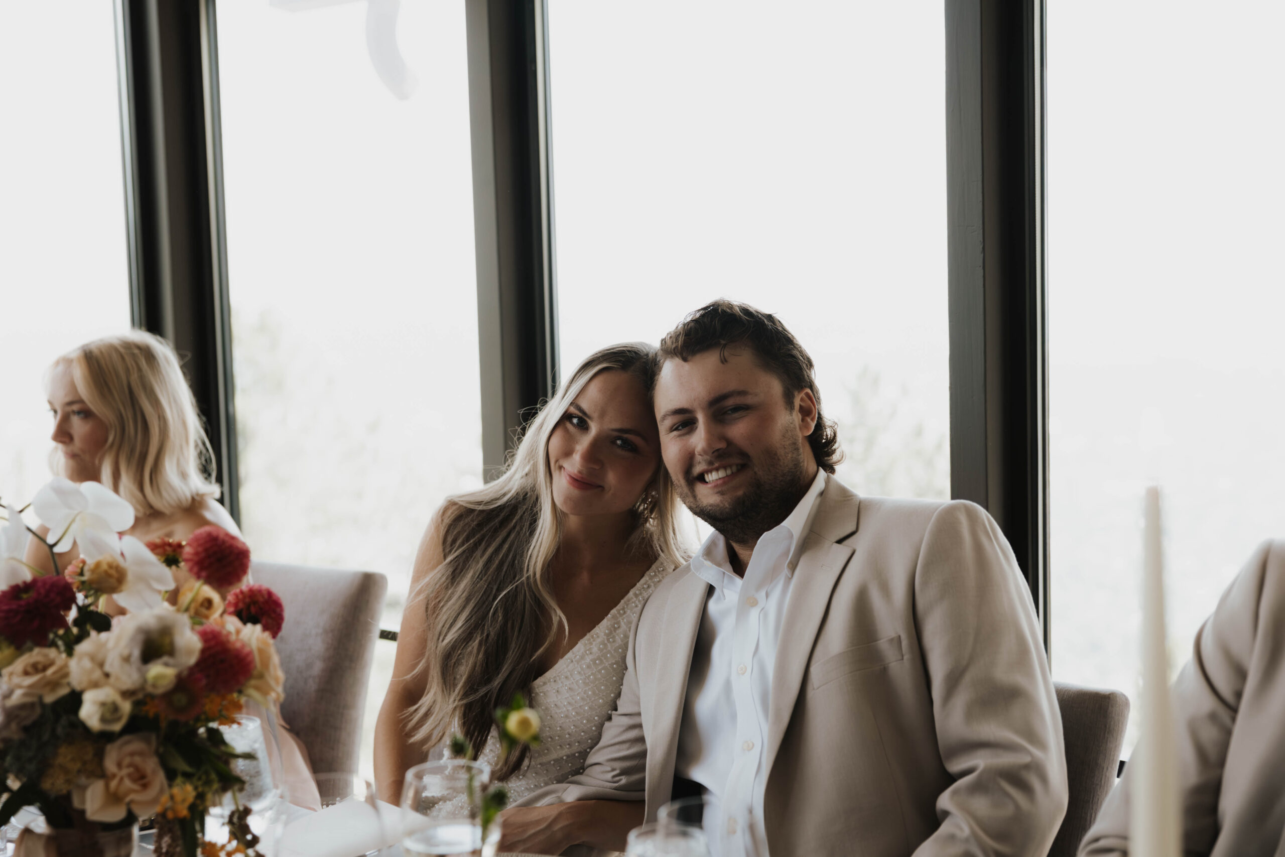 bride and groom smiling at their reception 