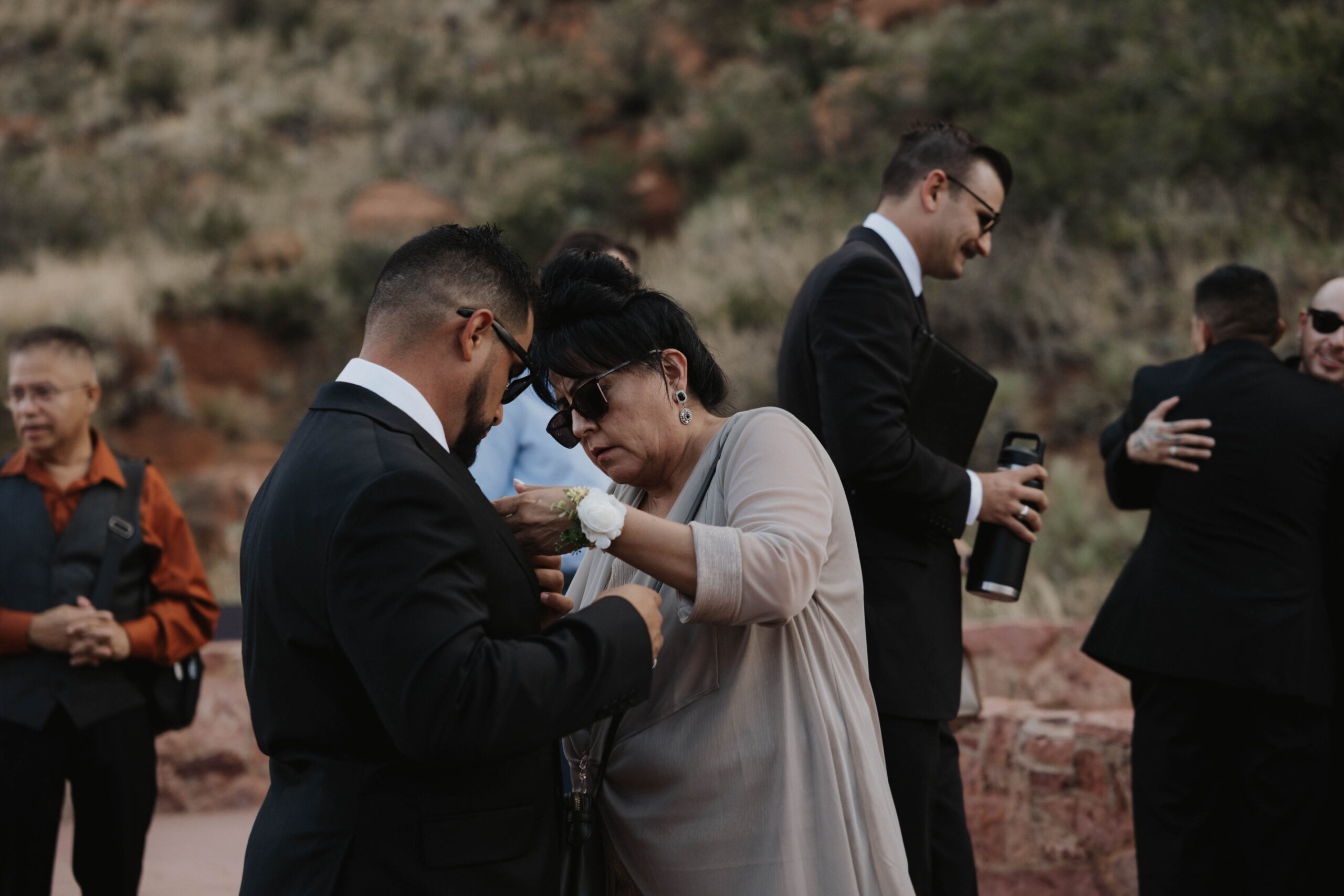 groom's mom helping him with his suit 