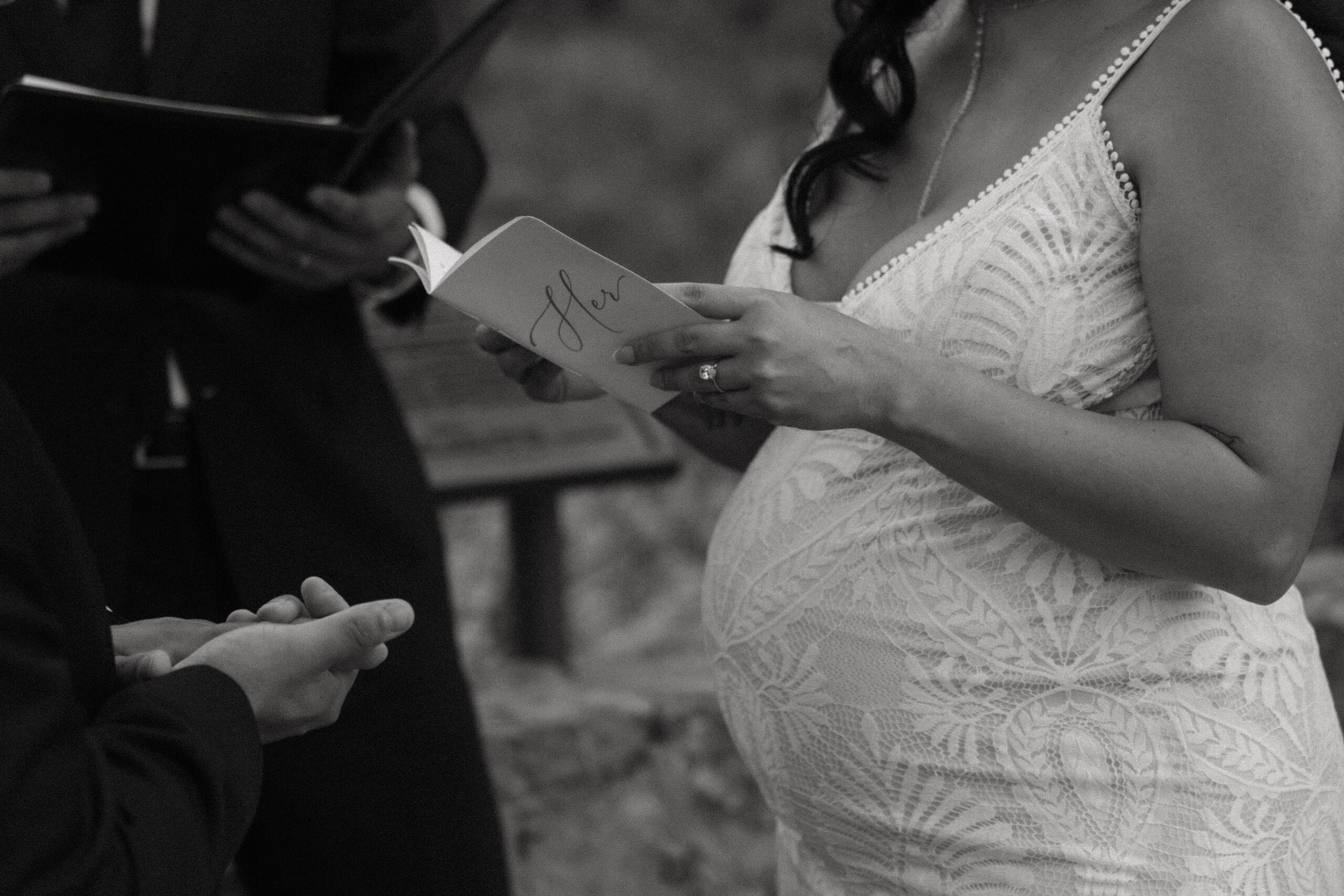 pregnant bride reading her vows 