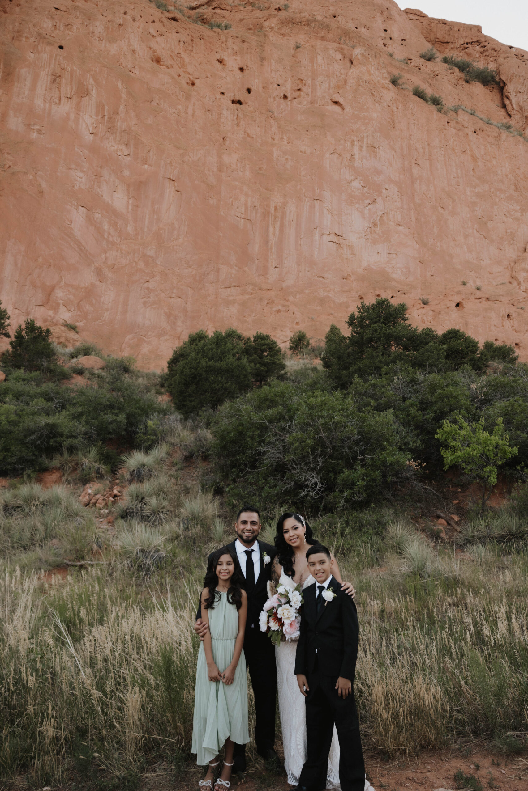 bridal couple and their kids taking a portrait 