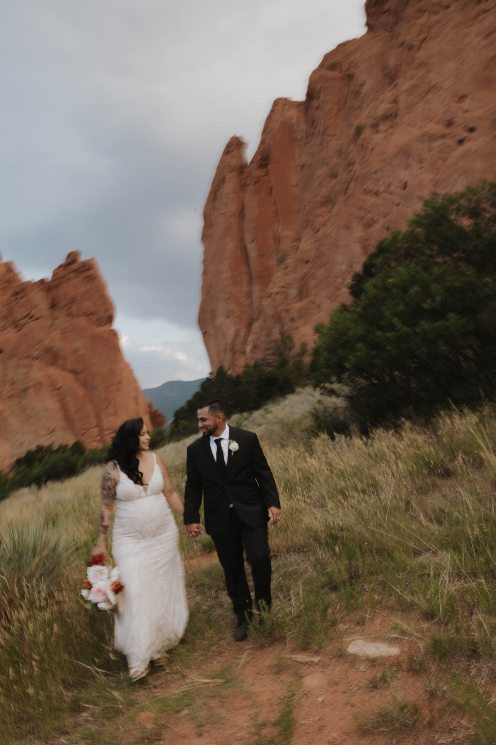 bride and groom walking during wedding at garden of the gods