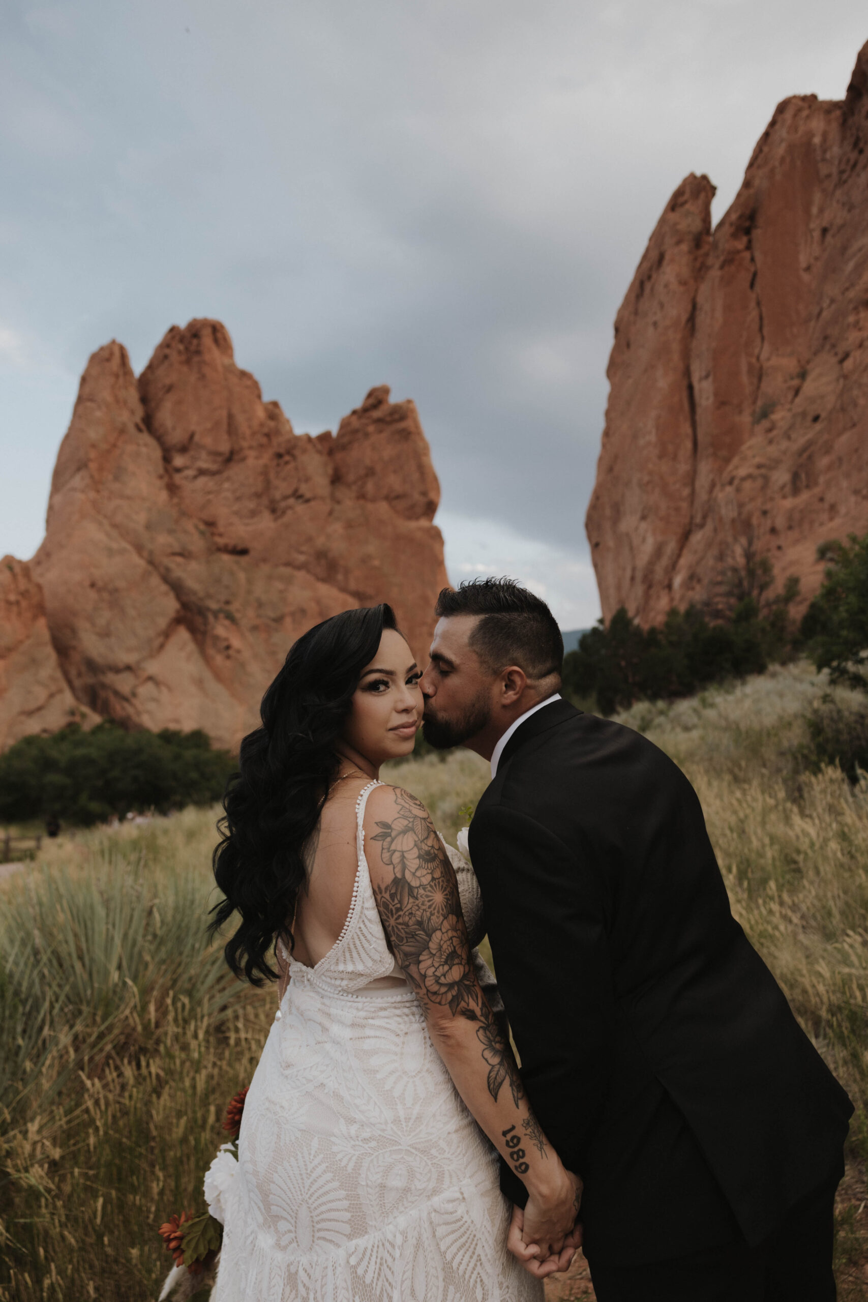 groom kissing bride on the cheek