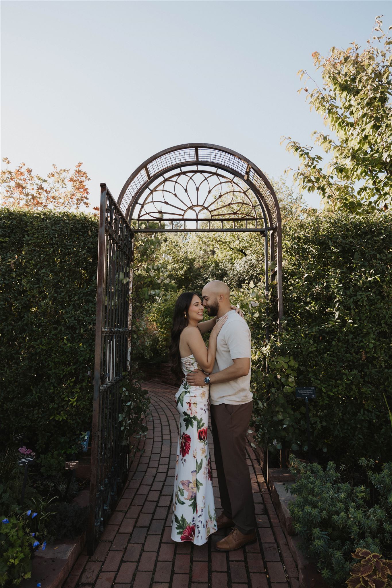 a couple holding each other in a garden during Denver Botanic Gardens Engagement Photos