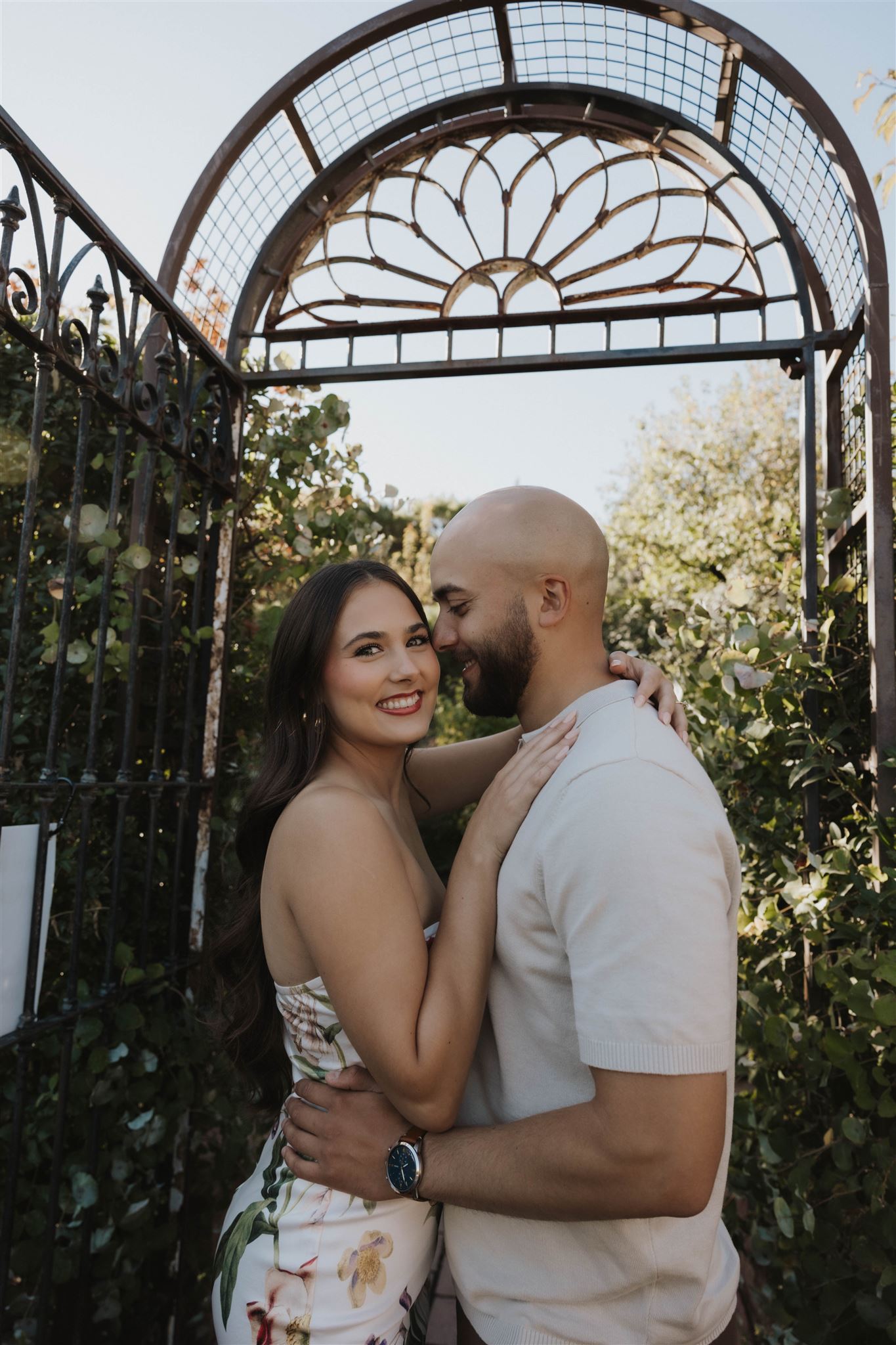 a couple smiling in the garden during Denver Botanic Gardens Engagement Photos