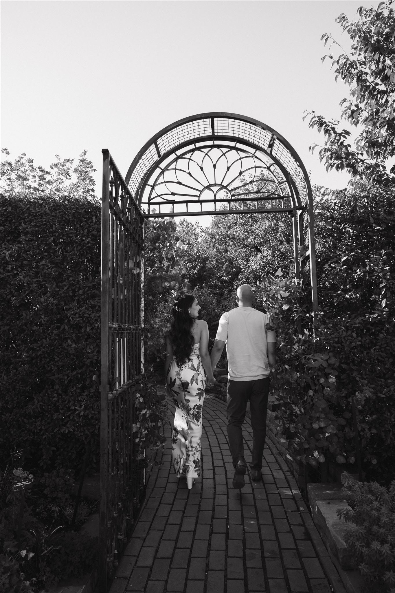 a couple walking away from the camera during Denver Botanic Gardens Engagement Photos