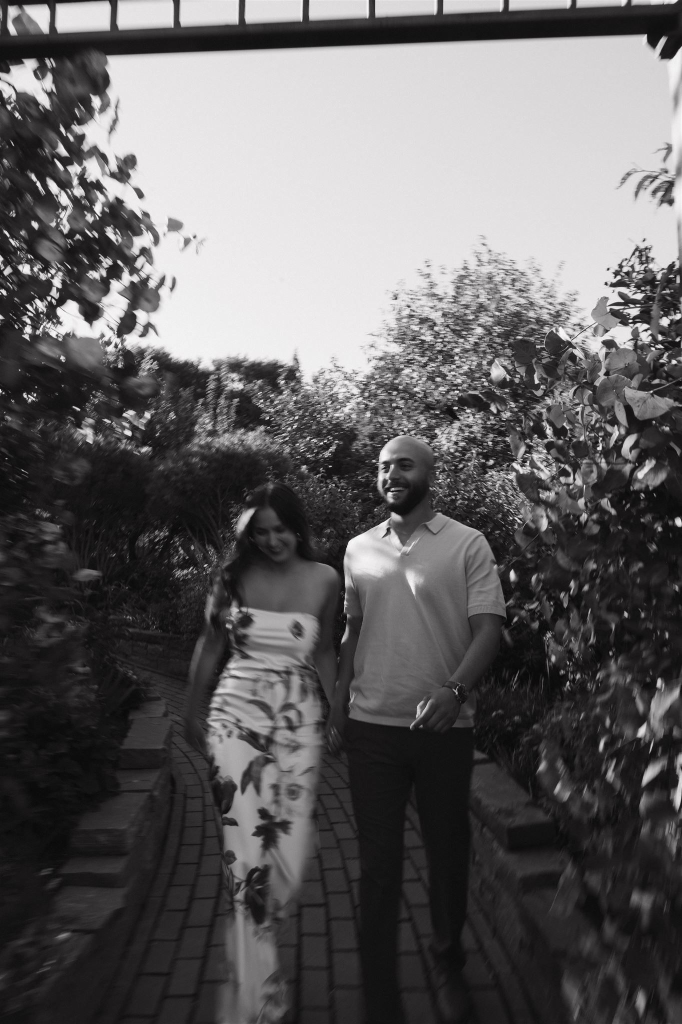 a candid photo of a couple walking and smiling 