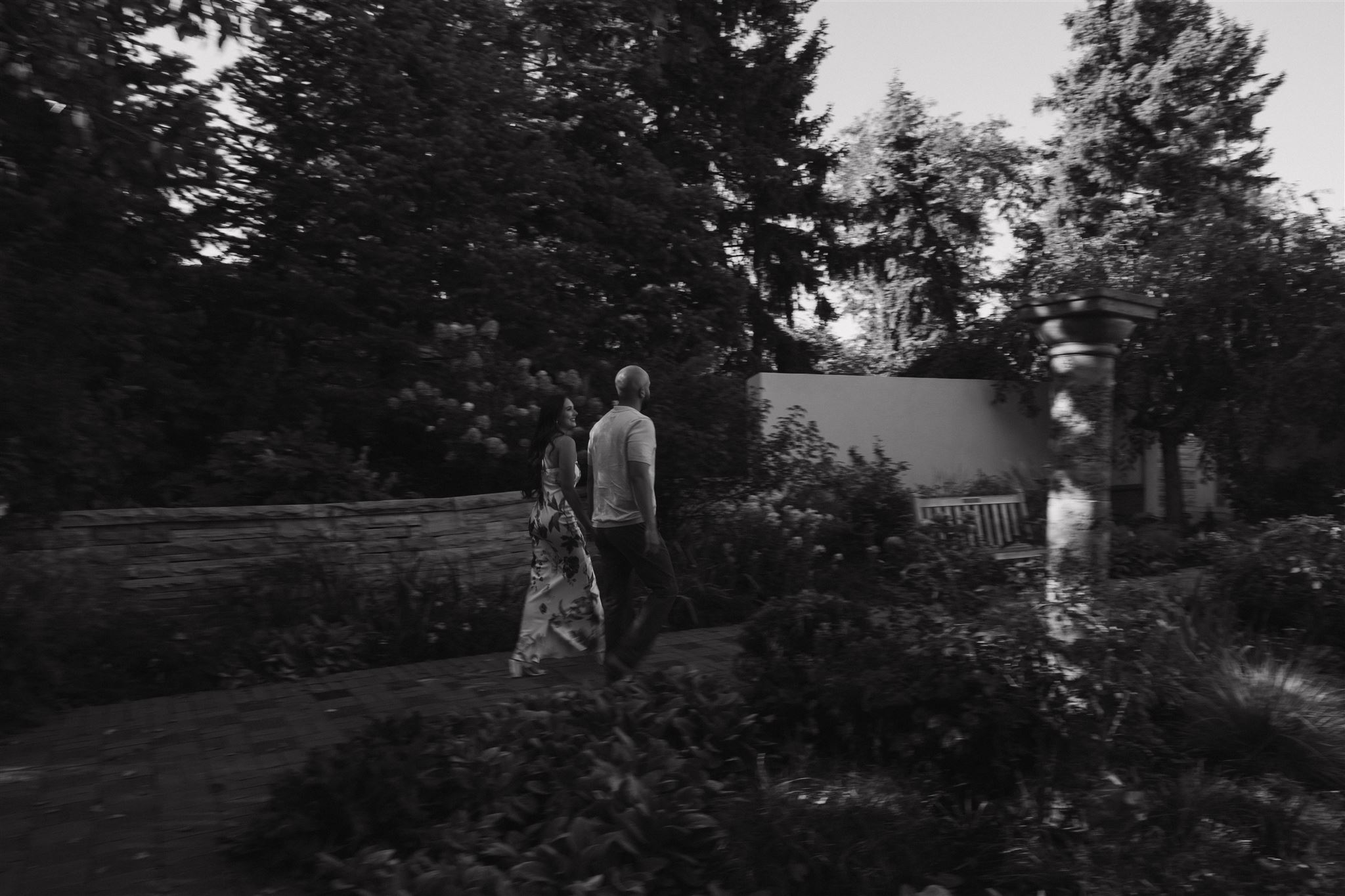 a couple walking through the garden during Denver Botanic Gardens Engagement Photos