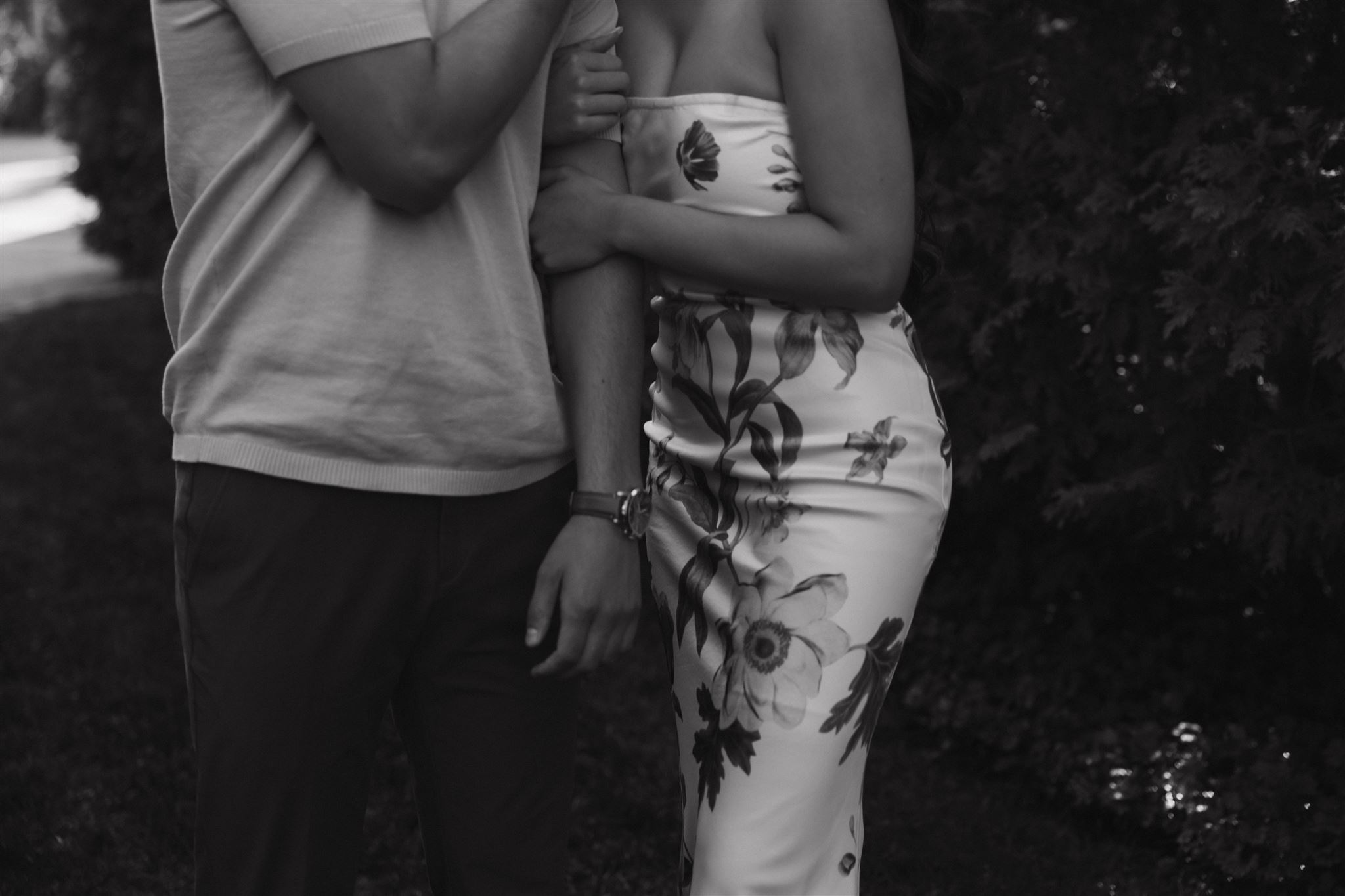 a woman holding on to a mans arm during Denver Botanic Gardens Engagement Photos