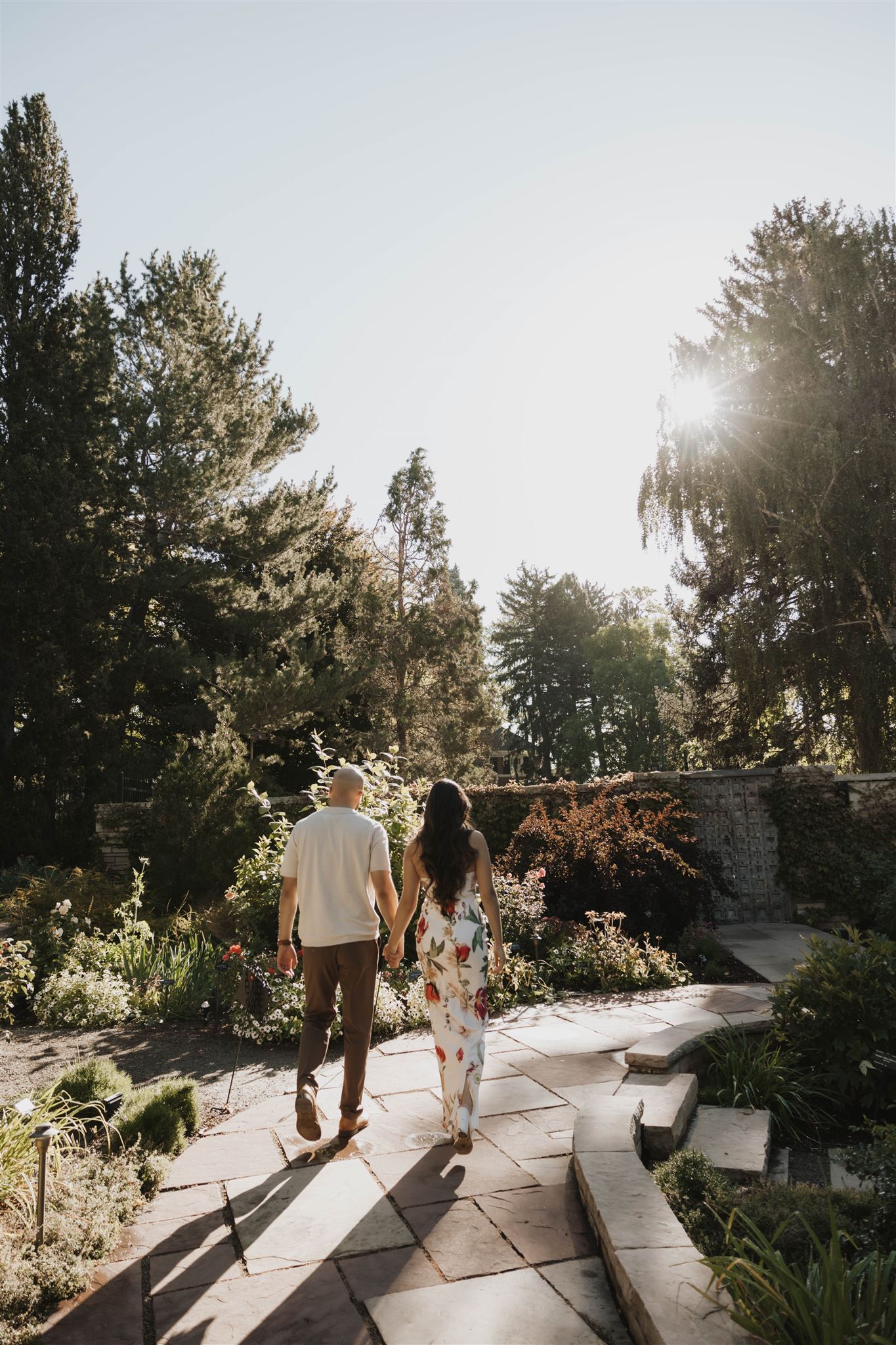 a couple walking together through the garden during Denver Botanic Gardens Engagement Photos