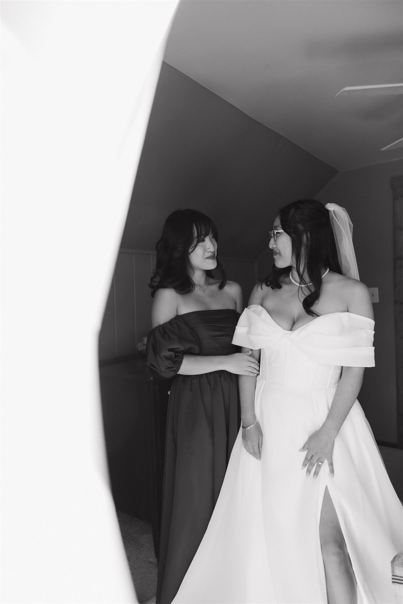 bride and her sister smiling at each other before the Sapphire Point Elopement