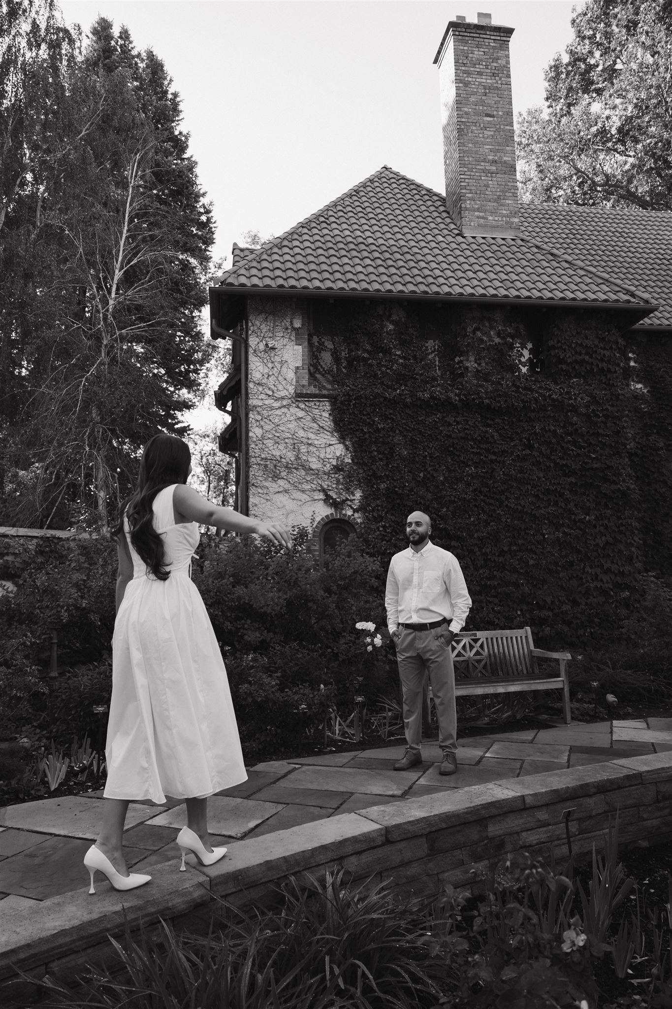 a couple walking by a fountain during their documentary engagement session