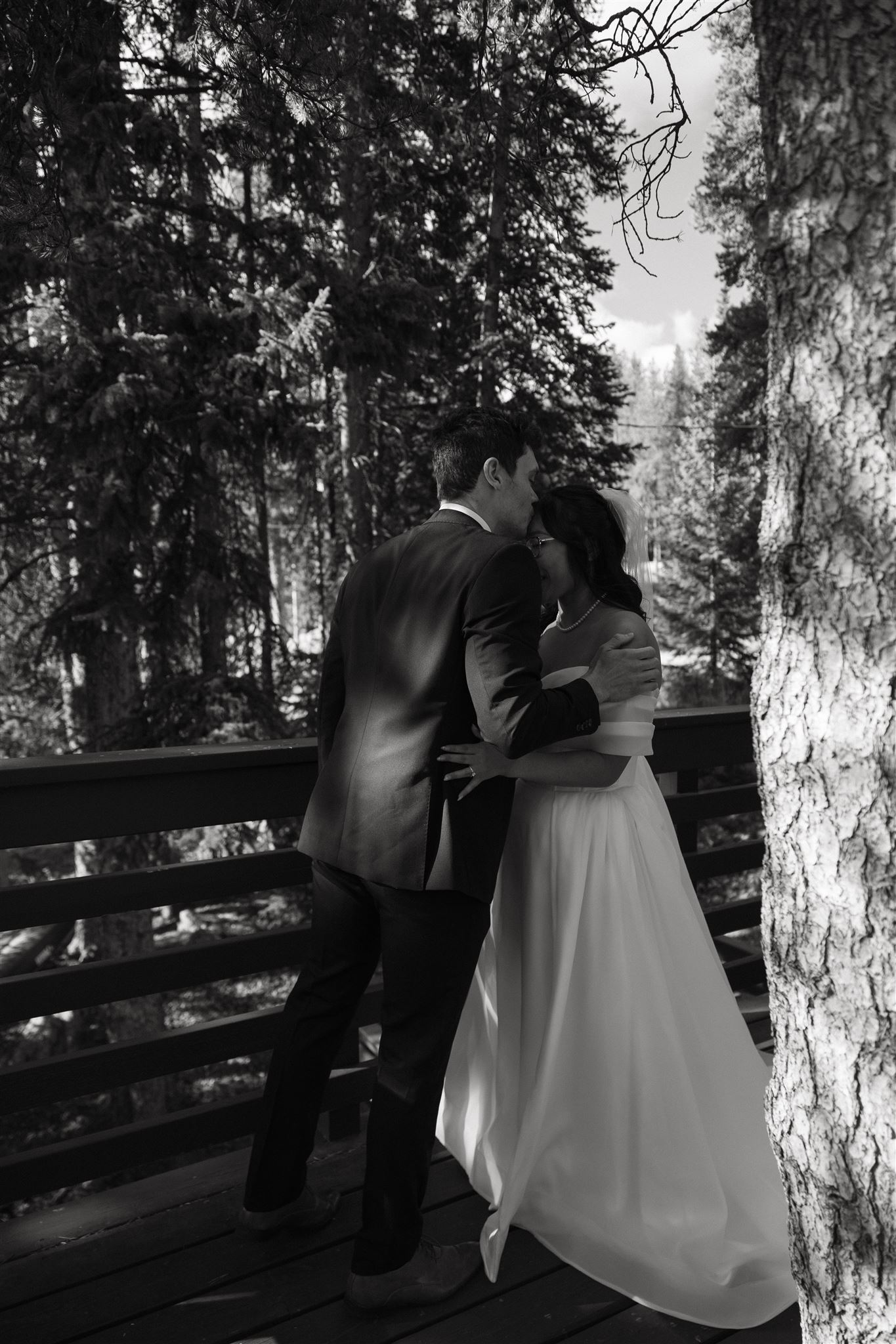 groom kissing bride on the forehead 