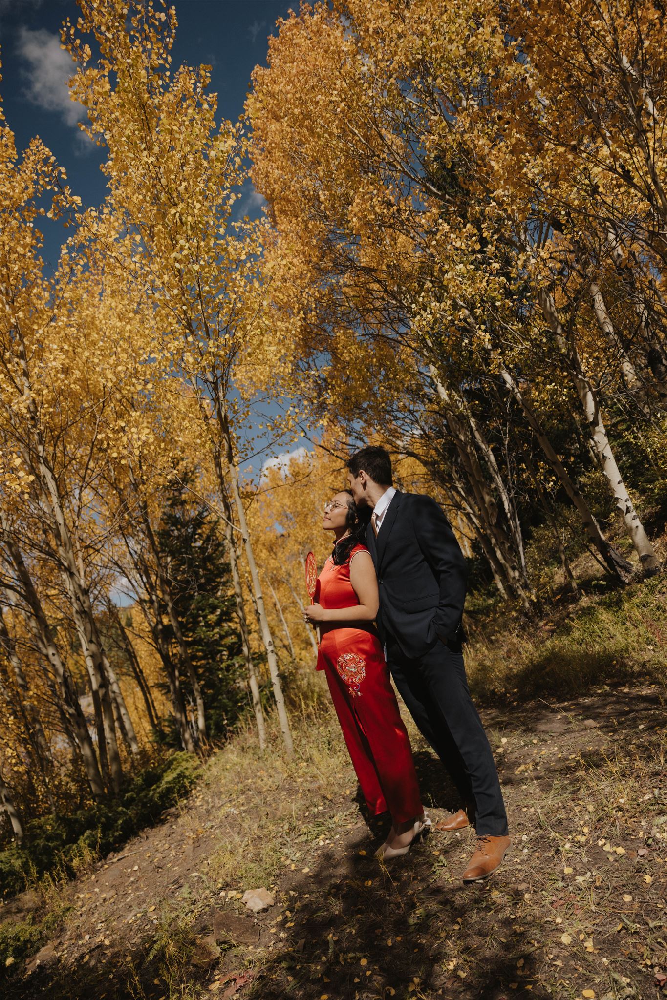 bride and groom pictures in the fall colored trees 