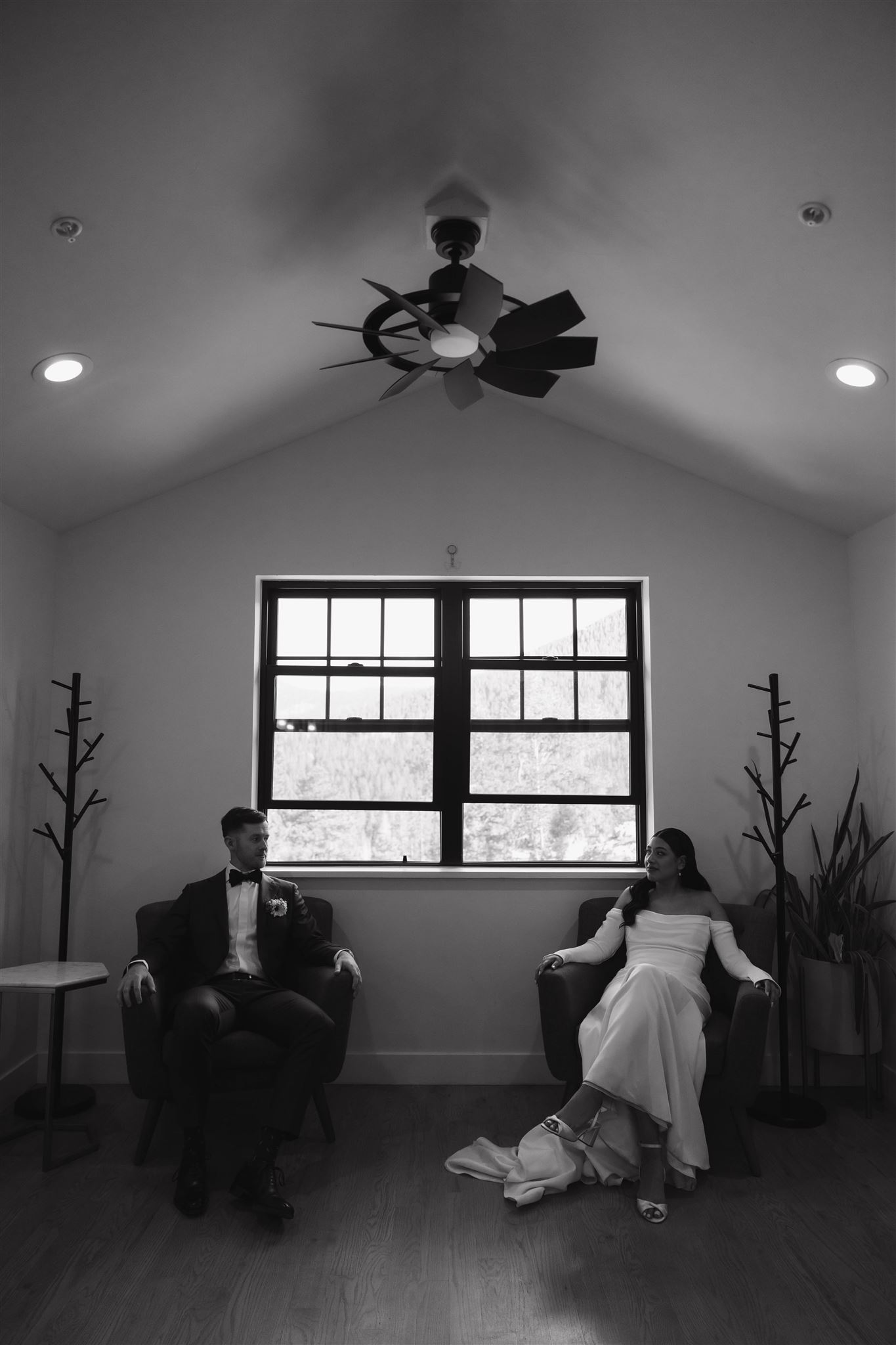 bride and groom sitting on chairs together 