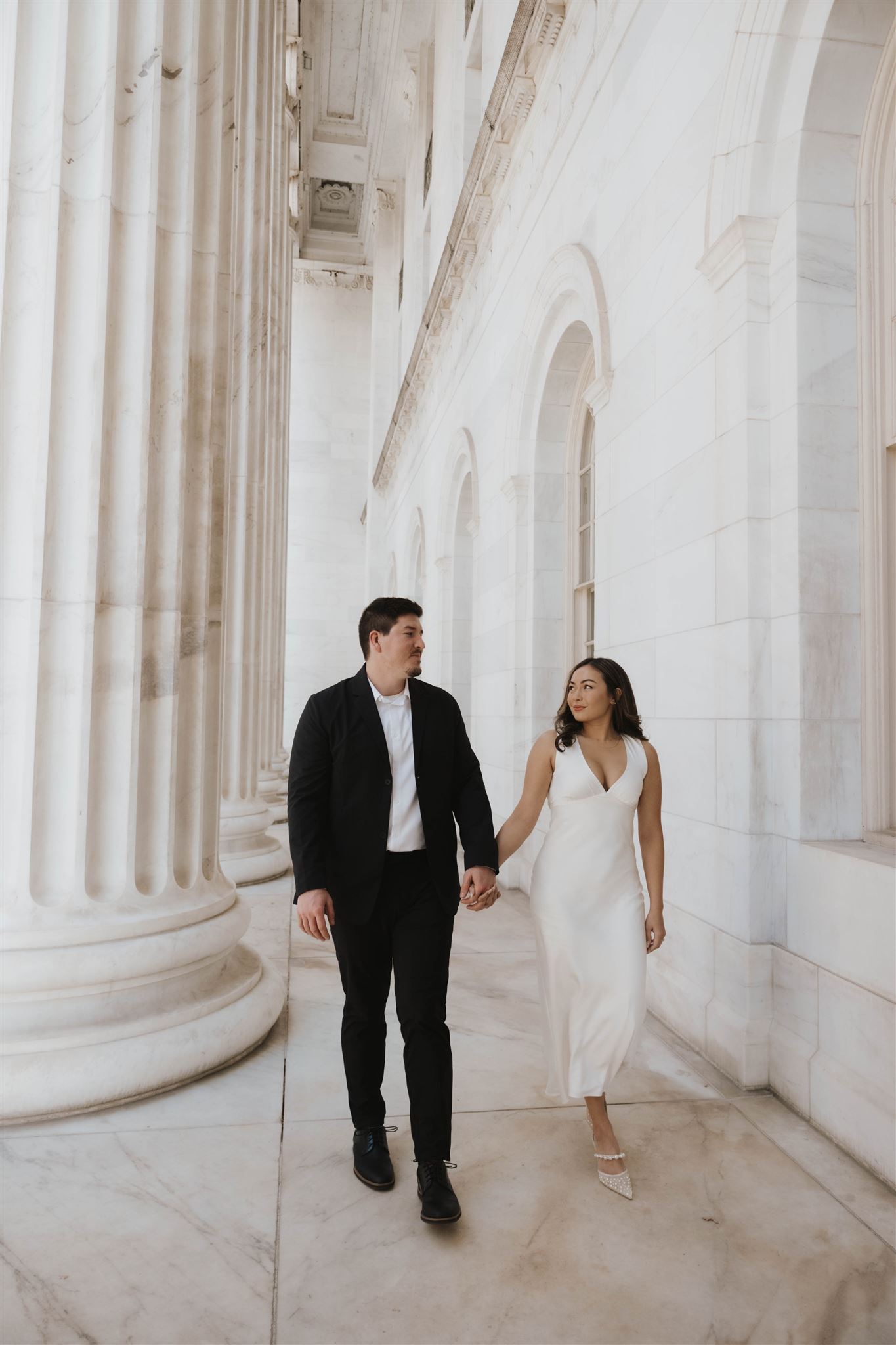 newly engaged couple walking together at the courthouse for their Elegant Engagement Photos