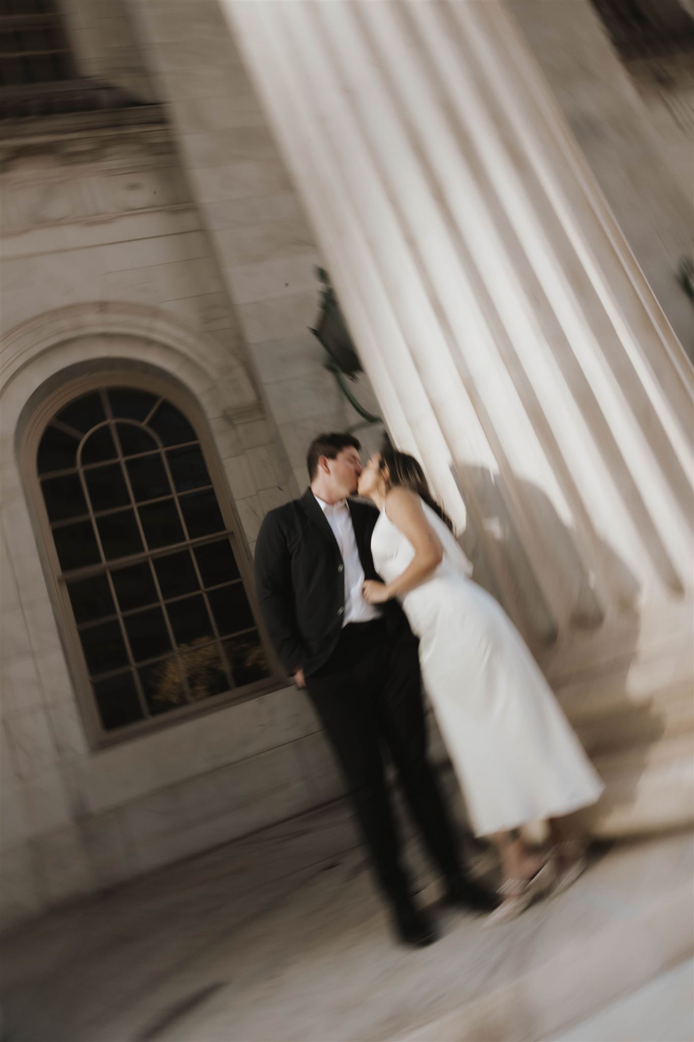 a blurry photo of a man and woman kissing during their Elegant Engagement Photos