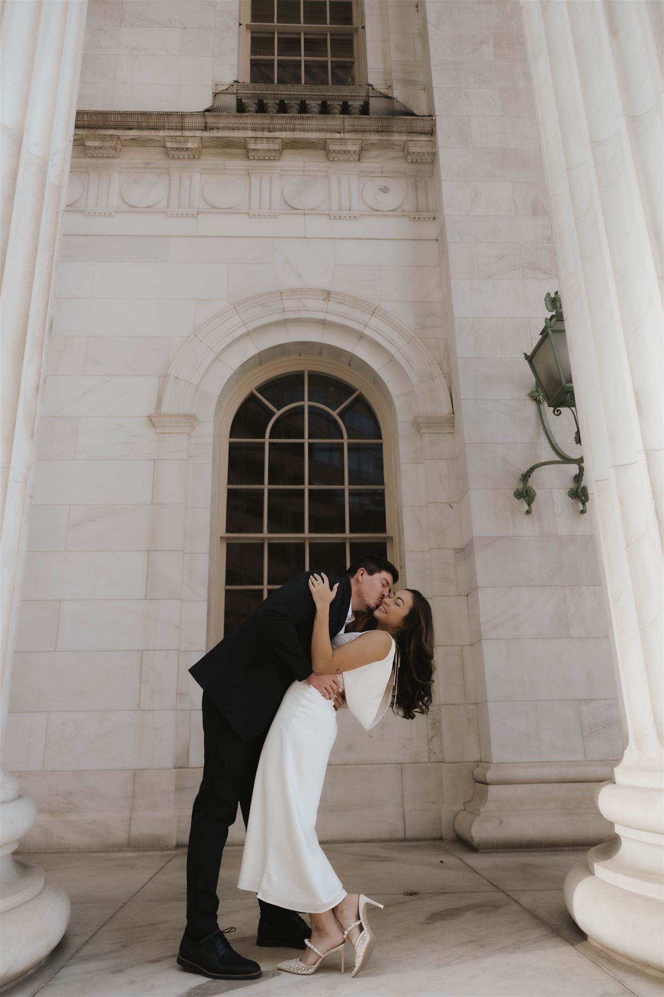 a man dipping and kissing a woman on the cheek during their Elegant Engagement Photos