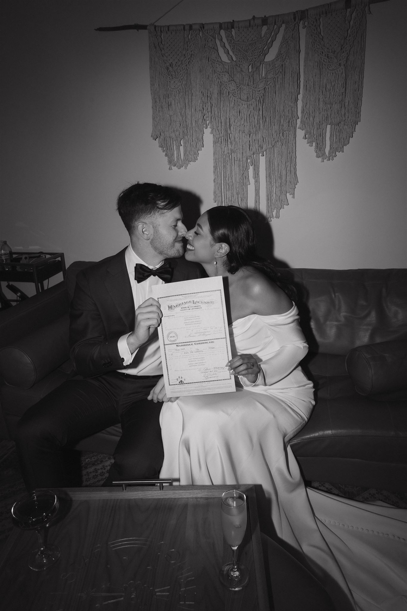 bride and groom holding up their marriage certificate 