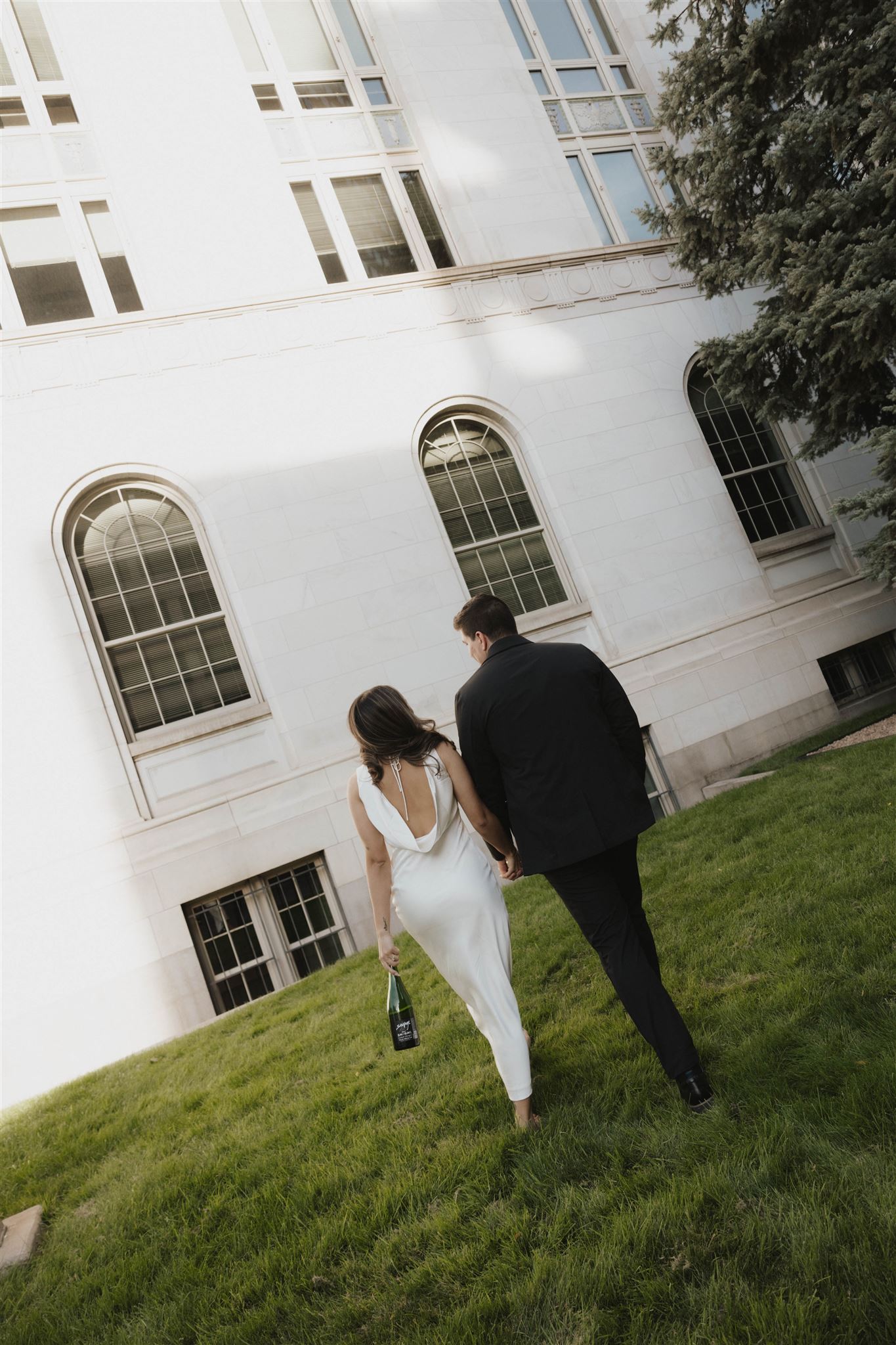 a man and woman walking away from the camera during their Elegant Engagement Photos