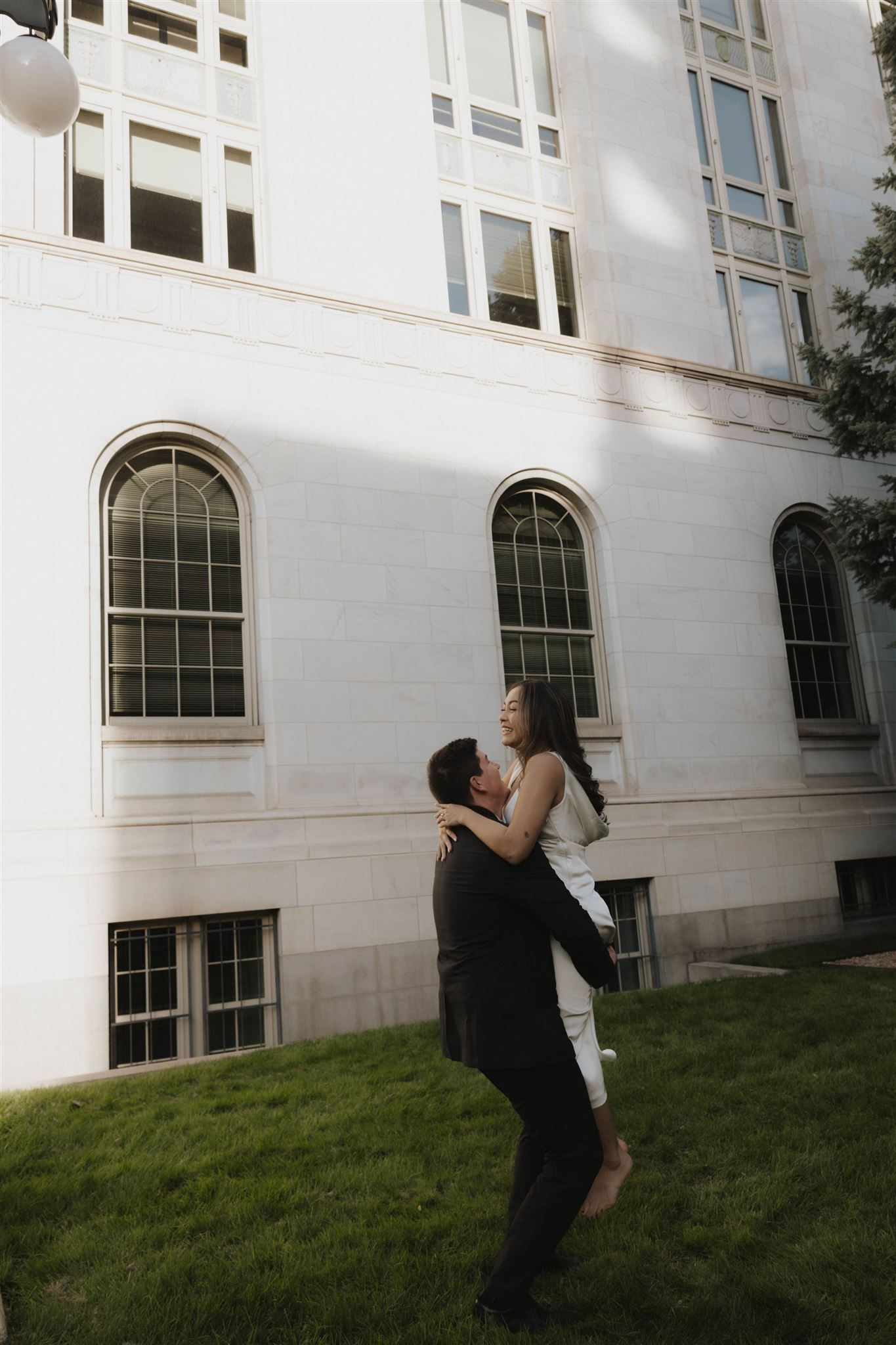 a man spinning a woman during their Elegant Engagement Photos