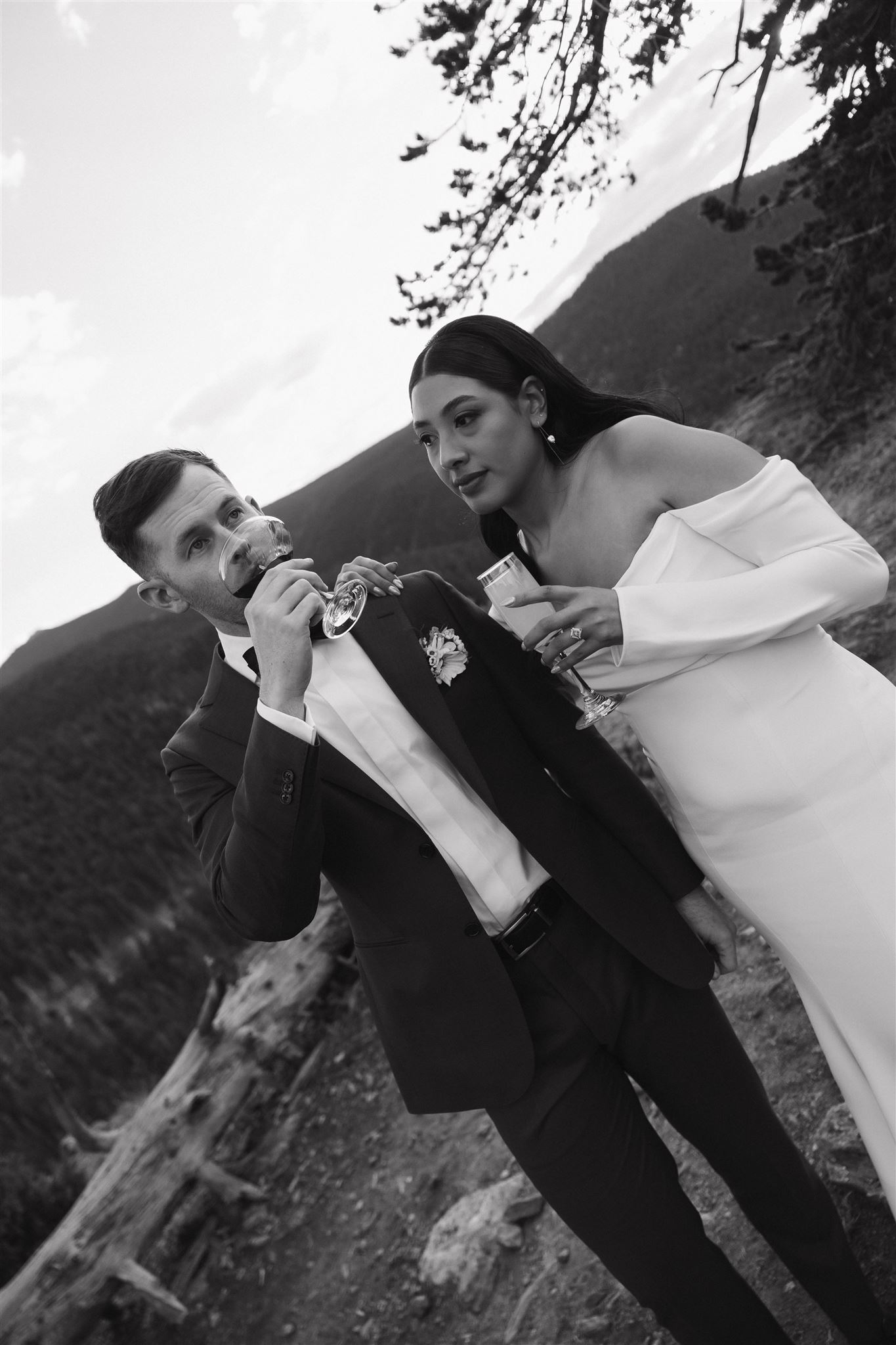 bride and groom holding their drinks outside 