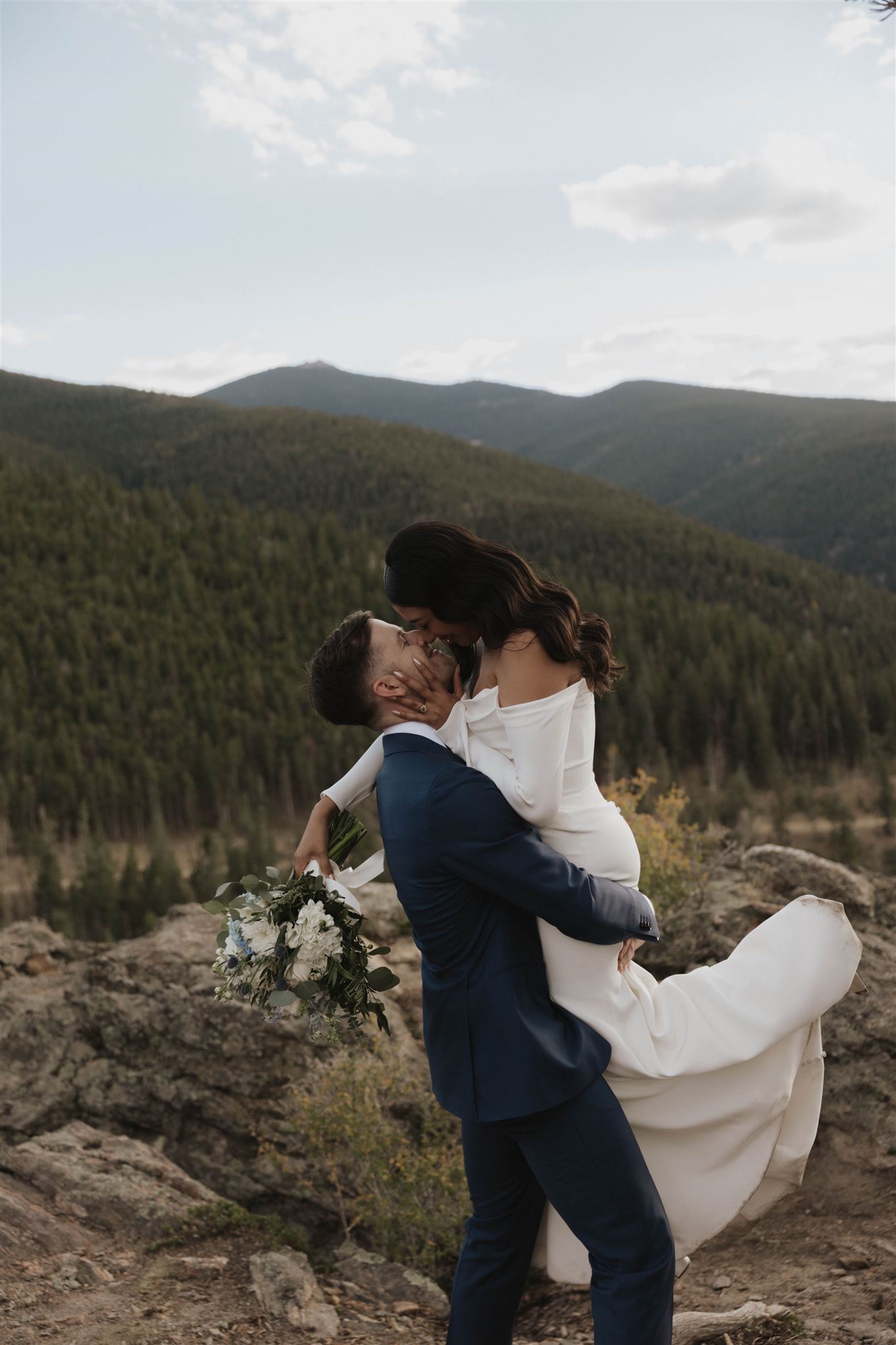 groom holding bride outside 