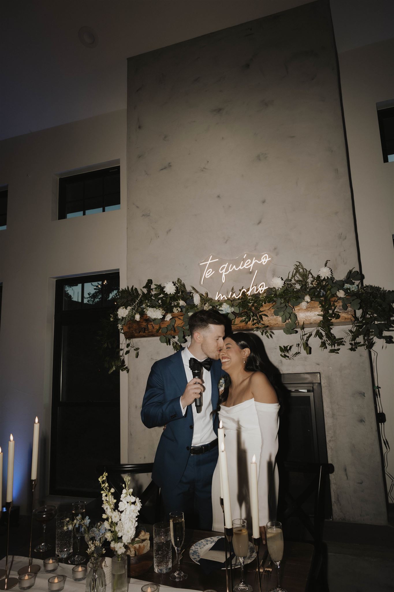 bride and groom standing at their head table 