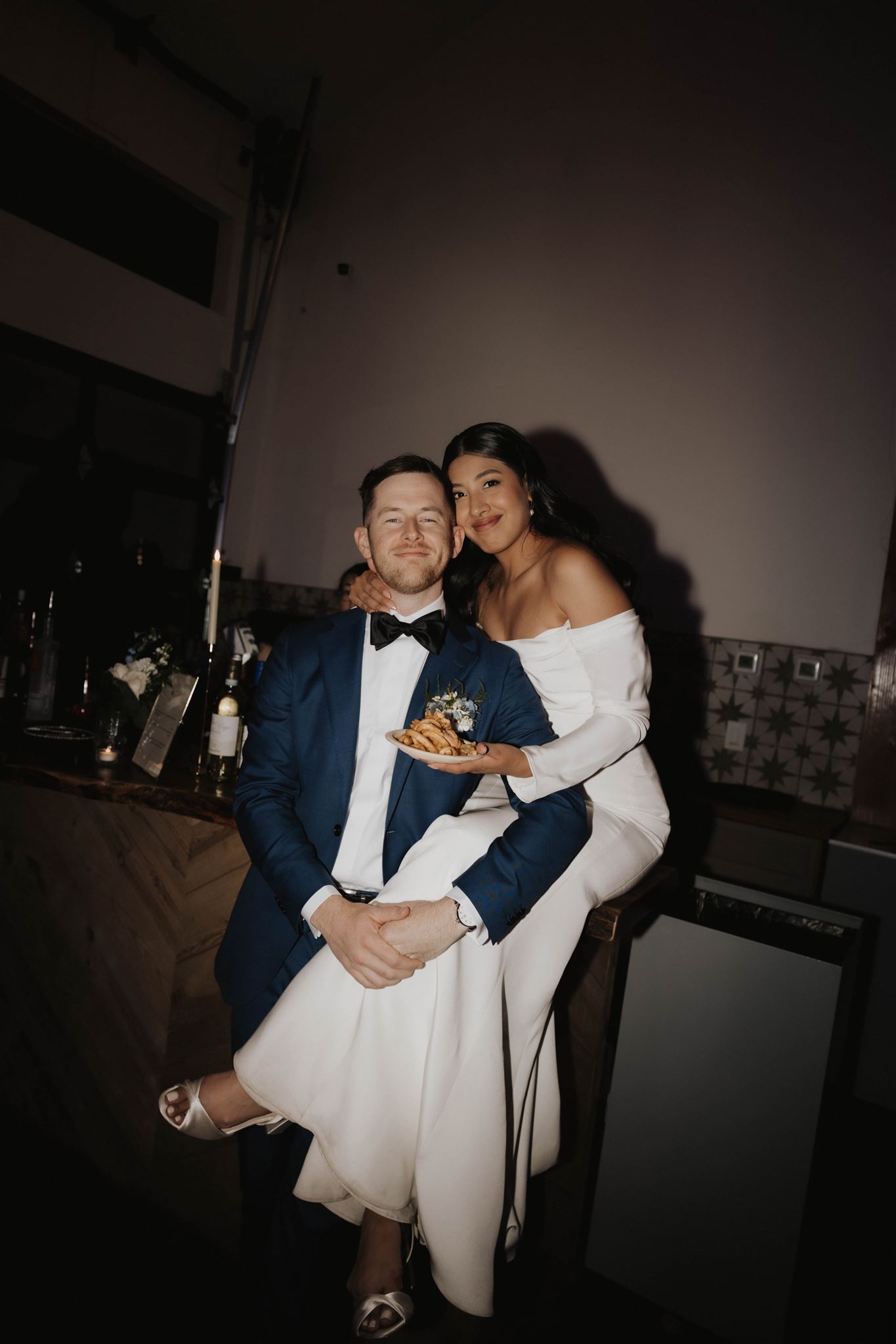 bride and groom with french fries at the Luxury Micro Wedding reception