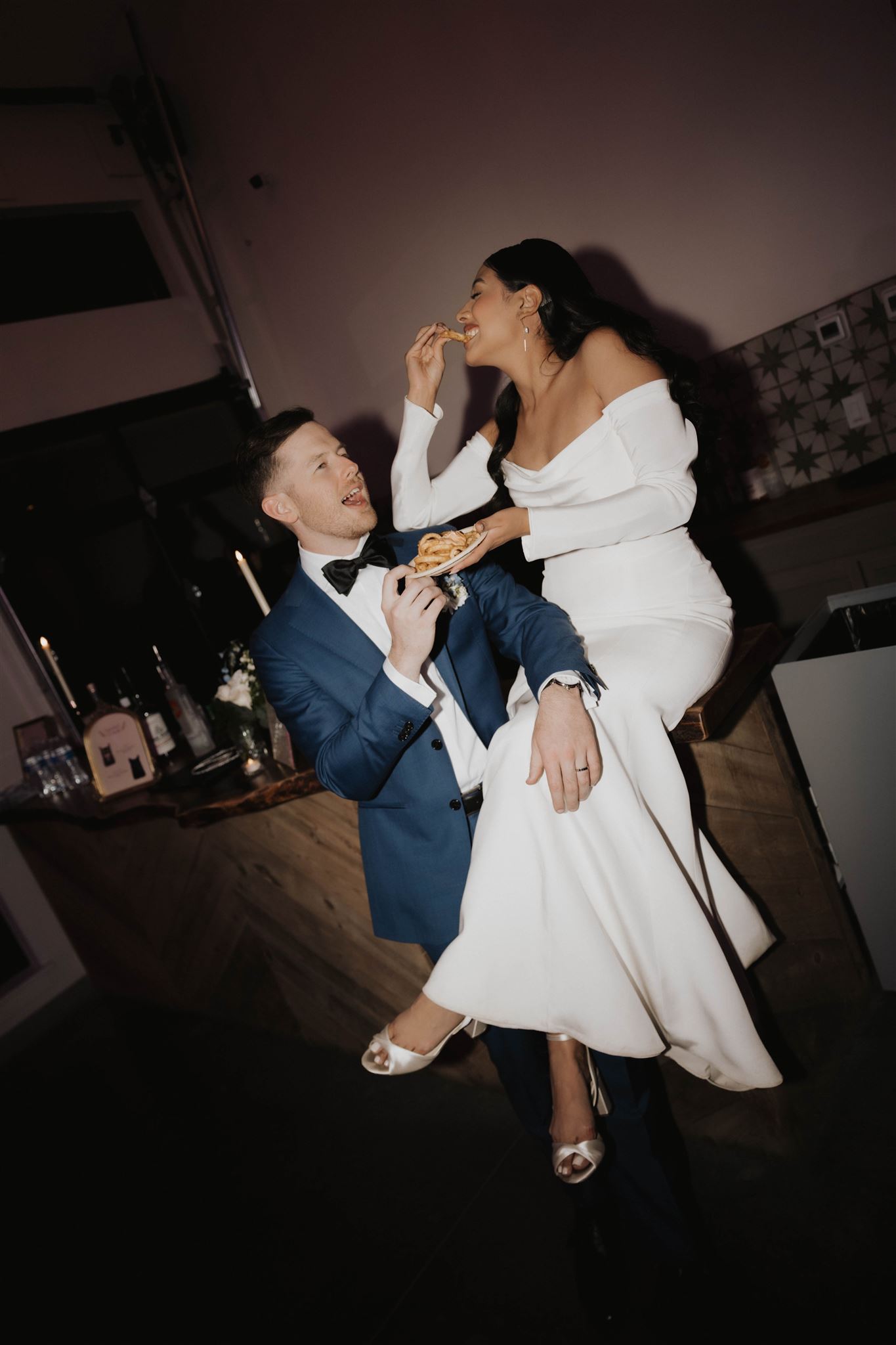 bridal couple eating french fries 