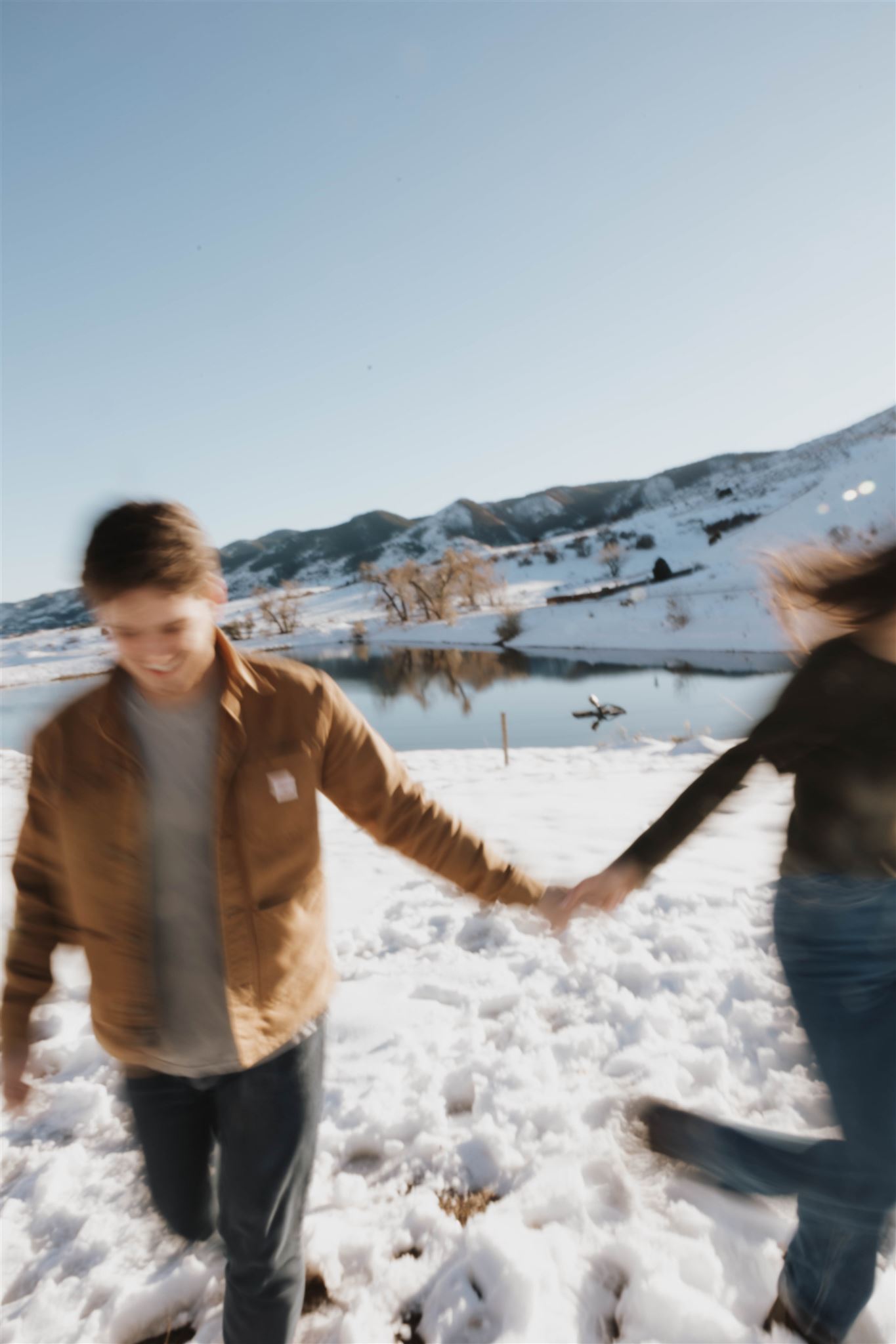 a blurry photo of a couple running together while holding hands 