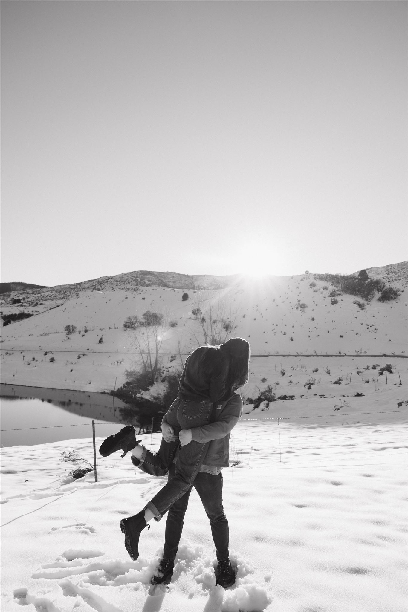 a man lifting a woman up in the snow in Colorado 